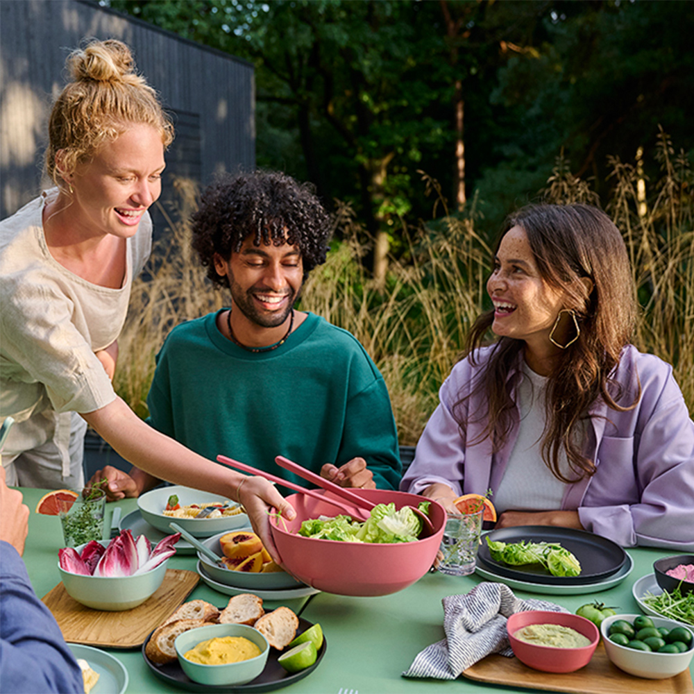 Friends enjoying a summer meal together outdoors