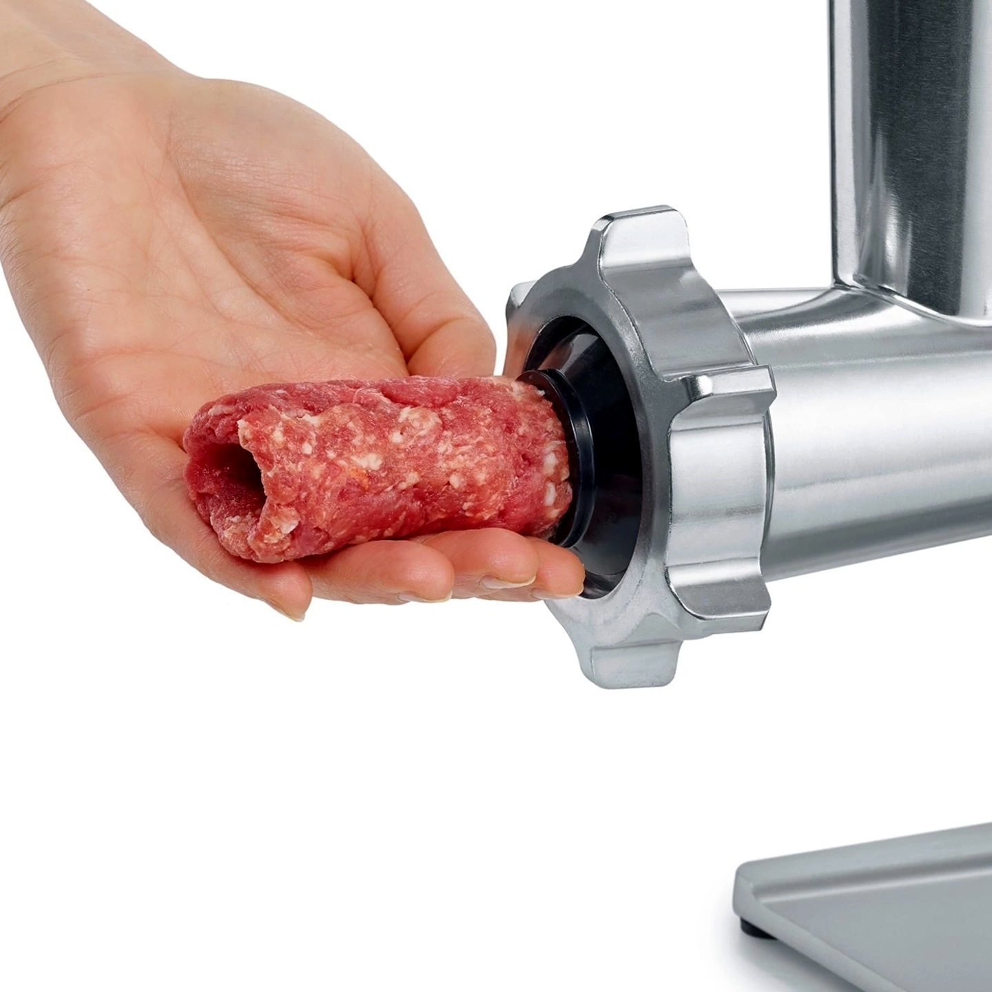 Hand shaping minced meat at grinder attachment