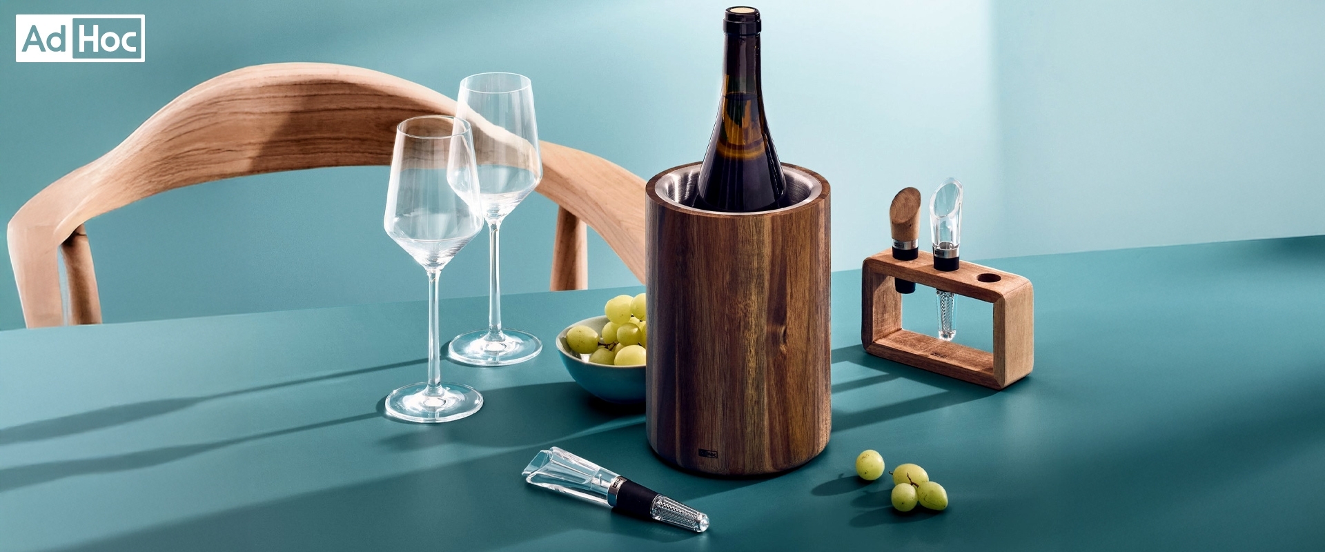 AdHoc wooden wine cooler with wine accessories on table