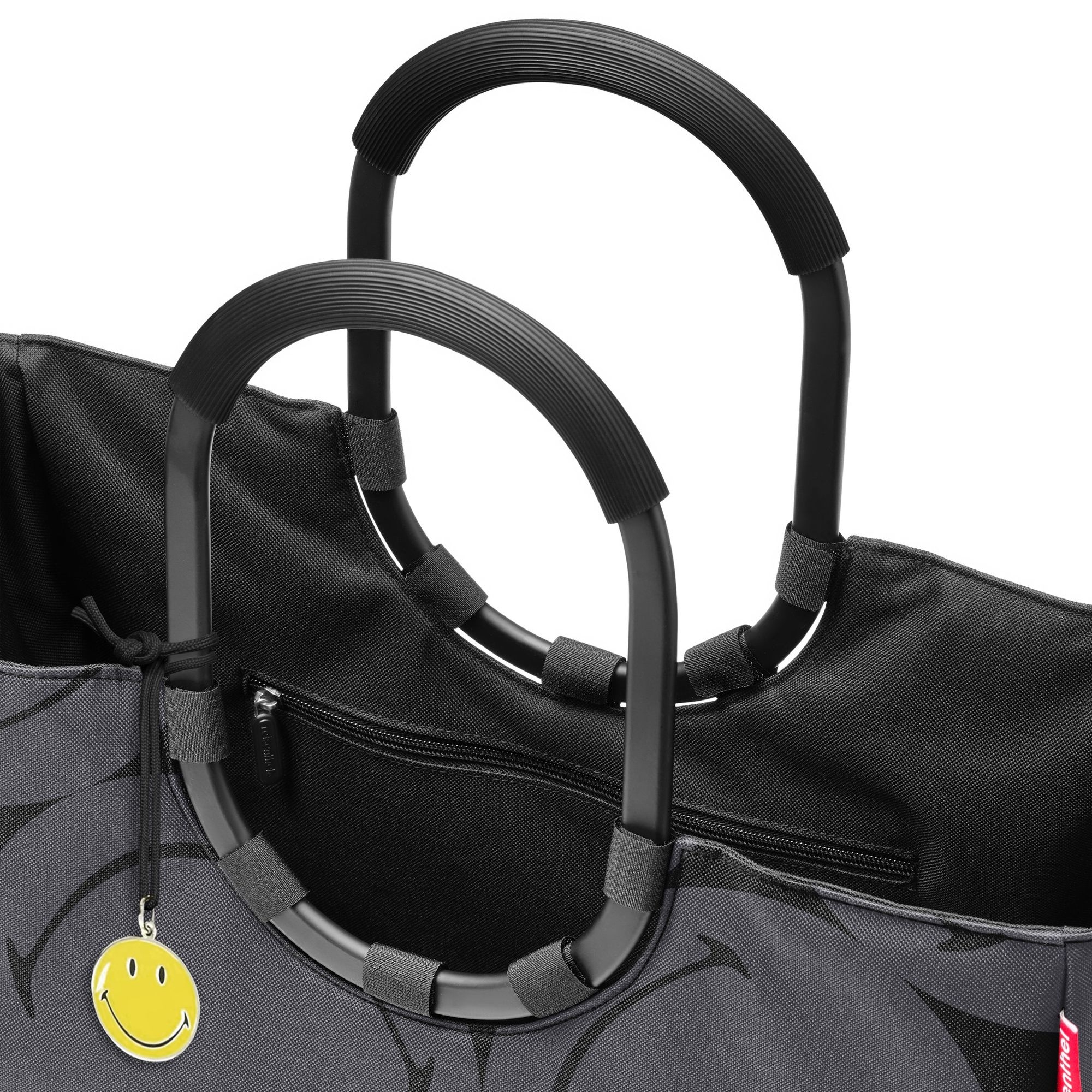 Black tote bag with round handles and smiley charm