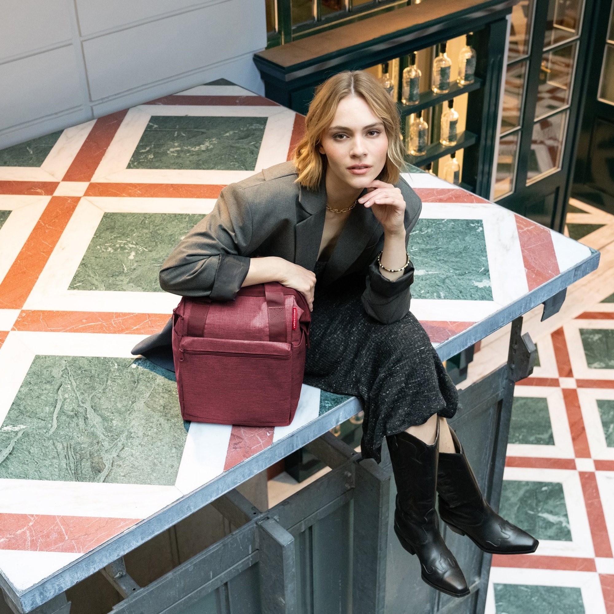 Woman with red shoulder bag on marble table