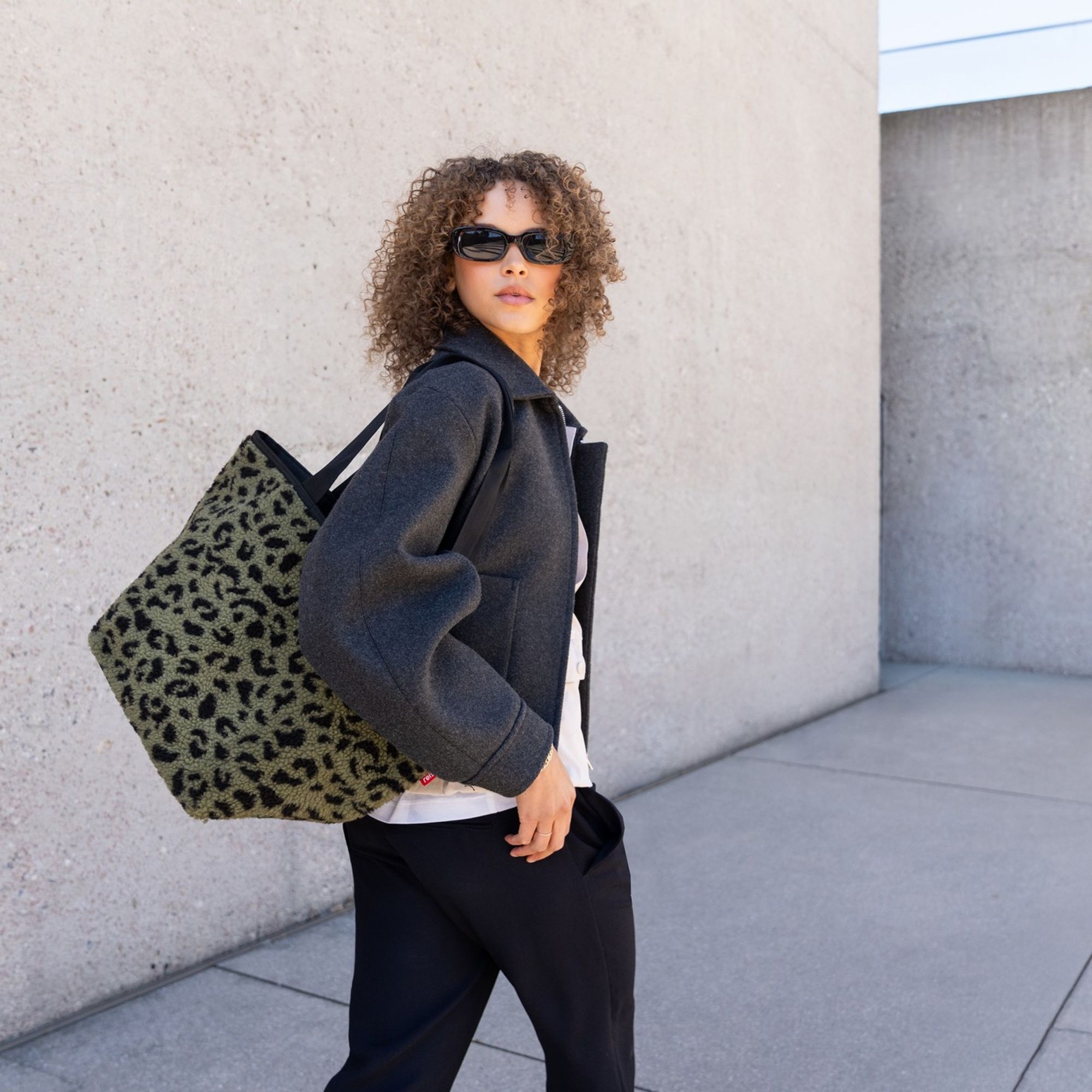 Woman with casual jacket and leopard print bag
