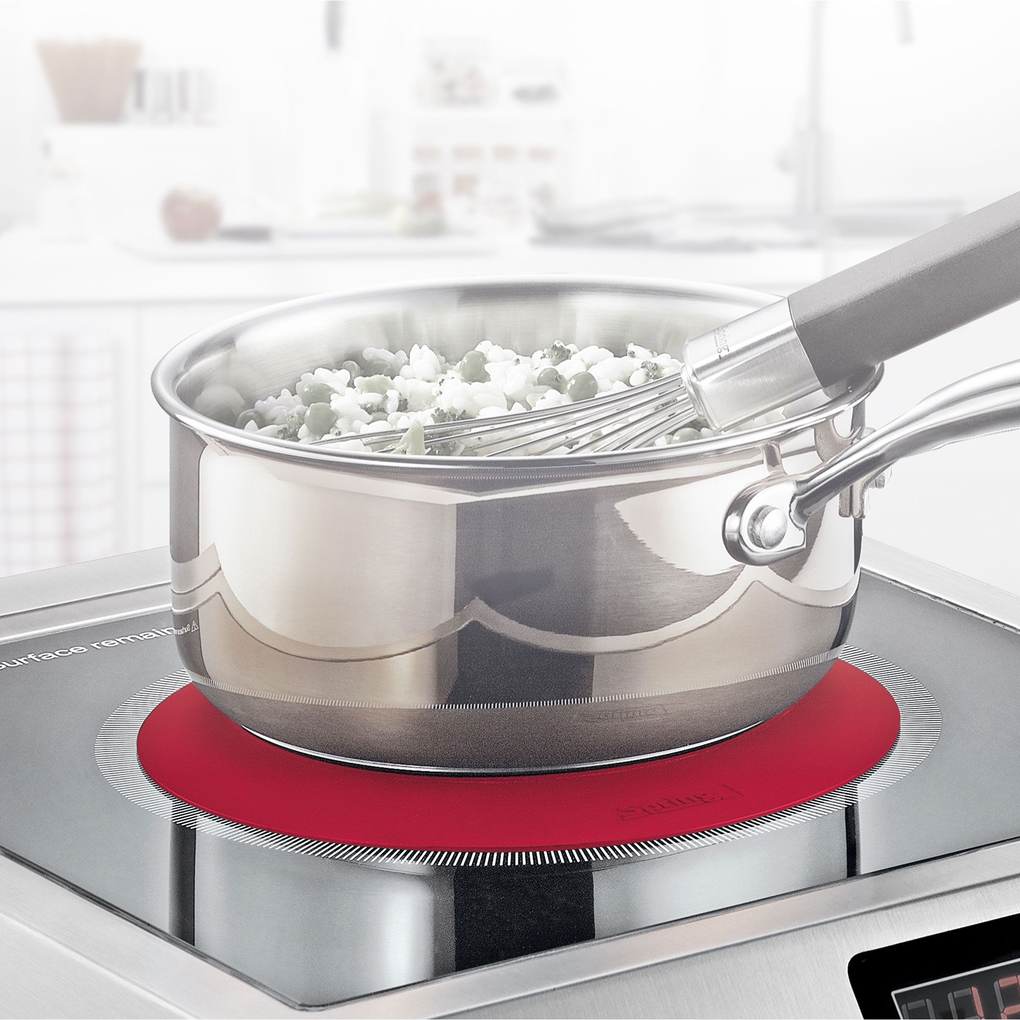 Stainless steel saucepan with vegetables on hob