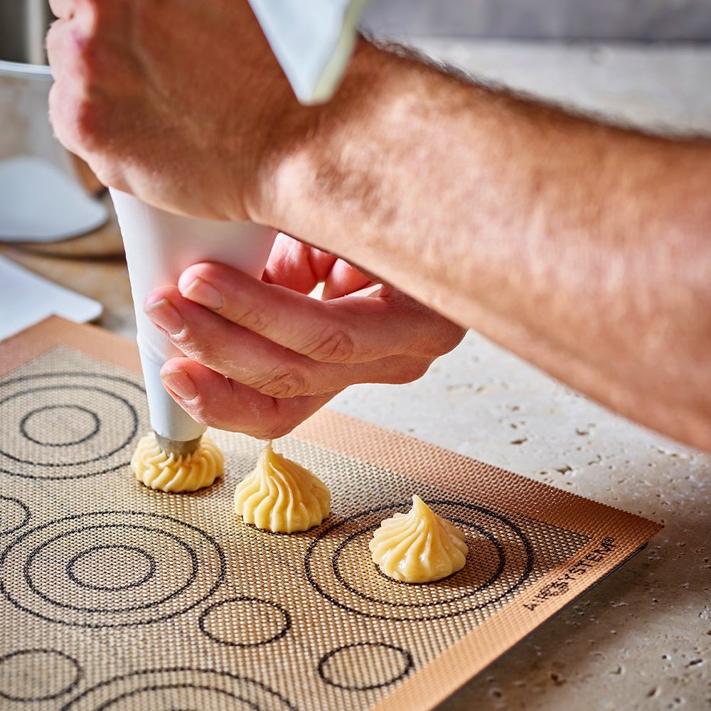 Portioning dough onto silicone baking mat with bag