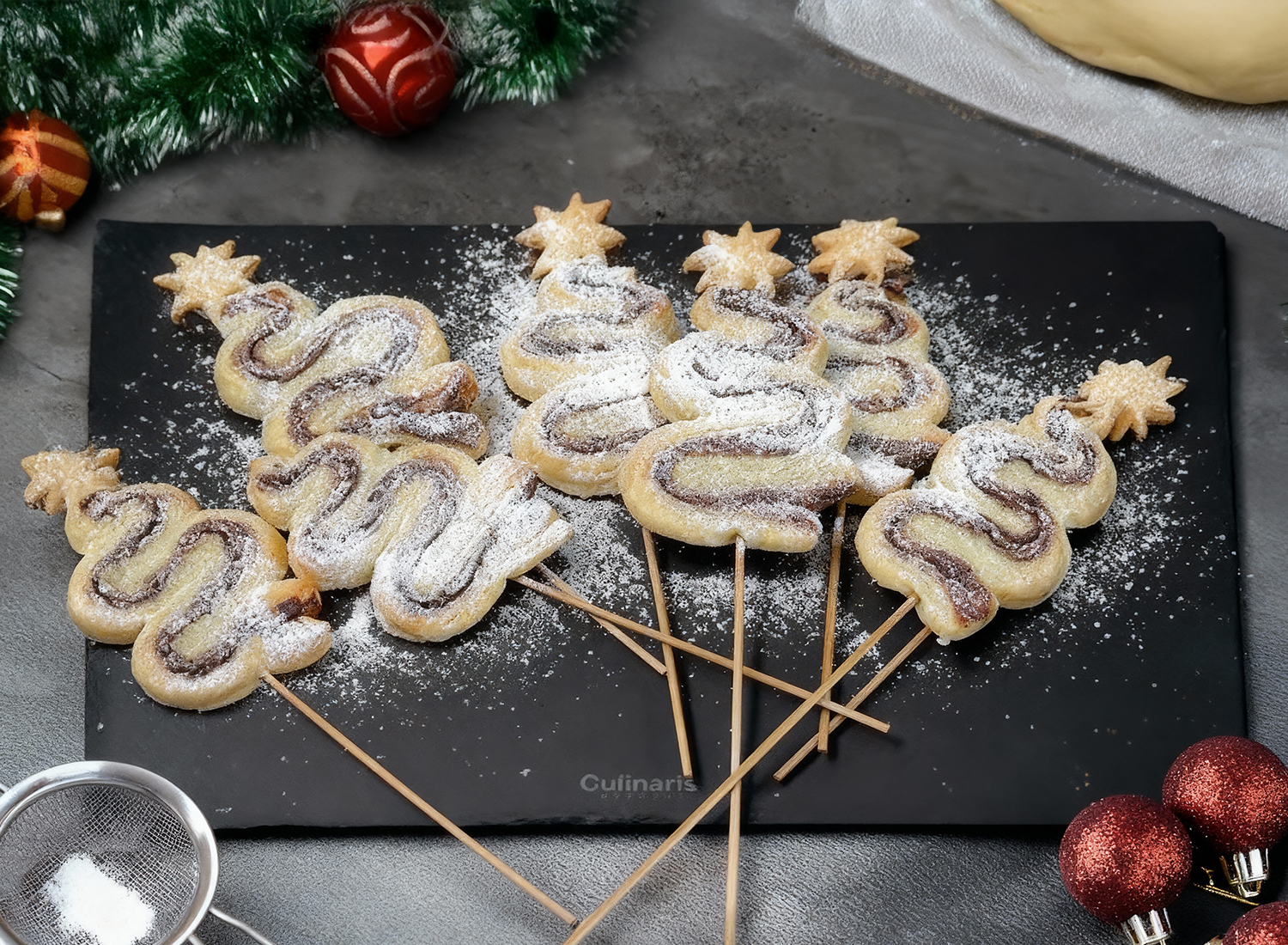 Puff pastry Christmas tree lollies dusted with icing sugar
