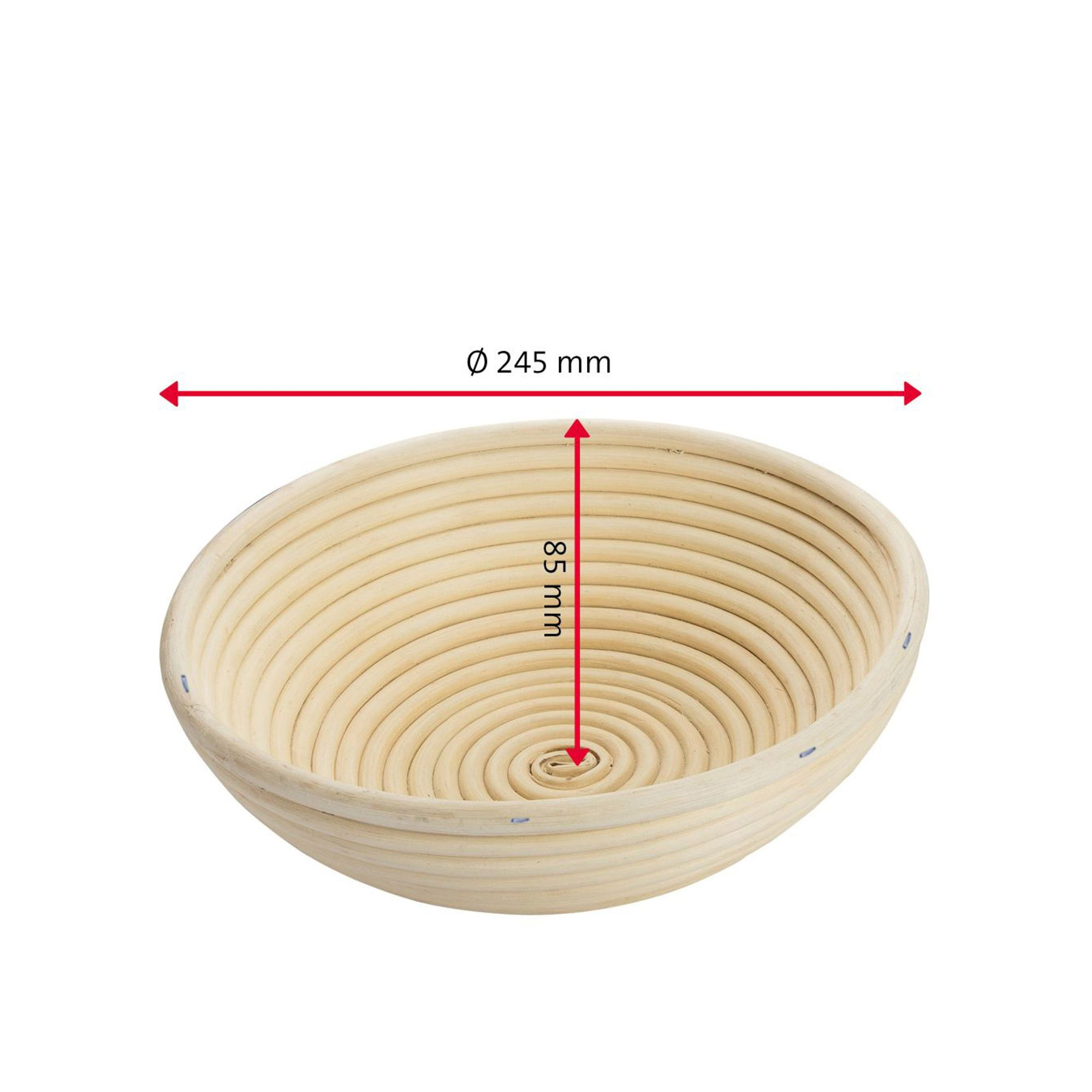 Round proofing basket with dough beside fresh bread