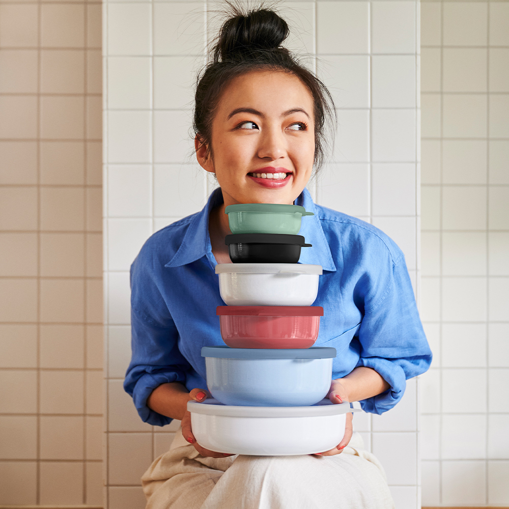 Woman holding stackable colourful food containers