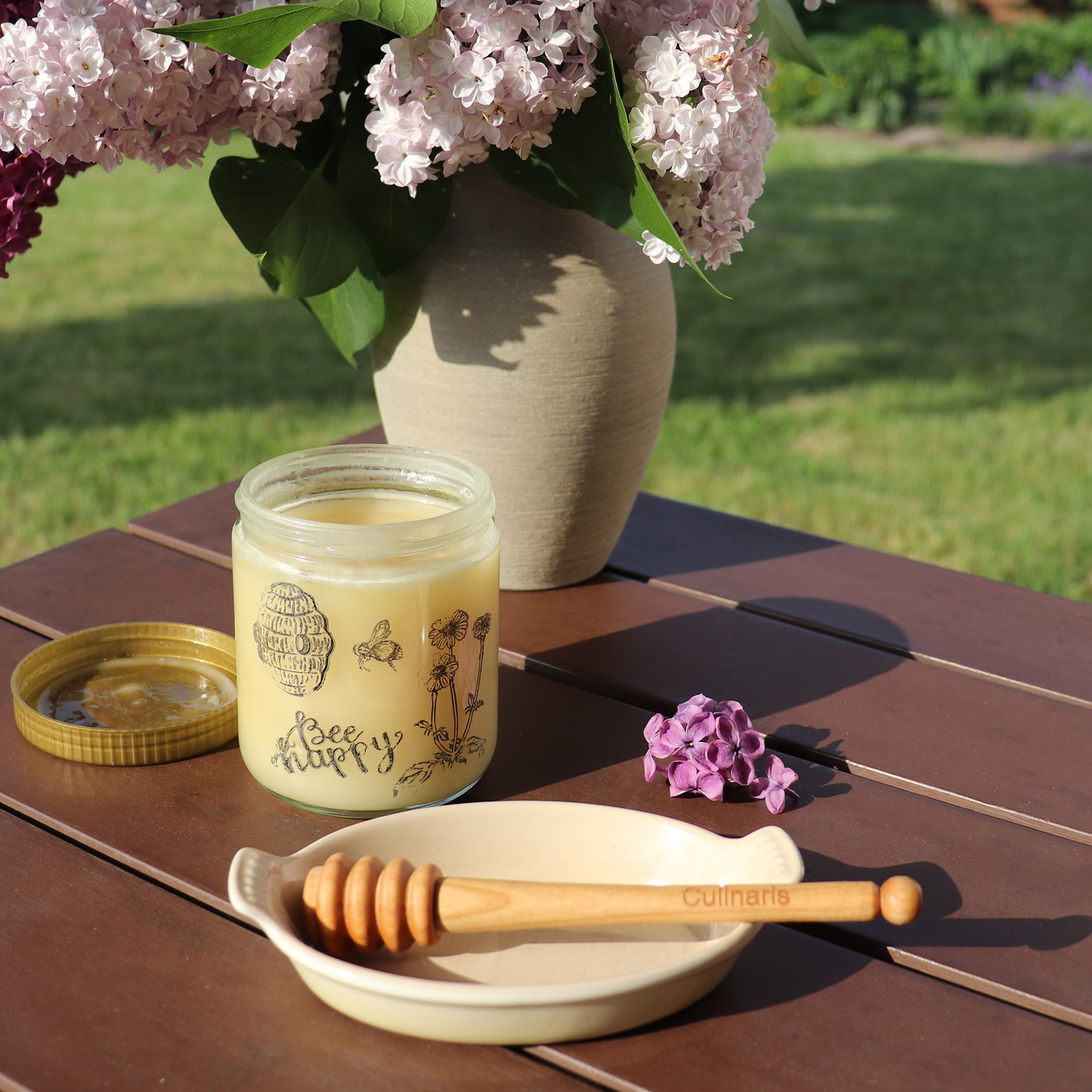 Culinaris cherry wood honey dipper, 15 cm, next to honey jar