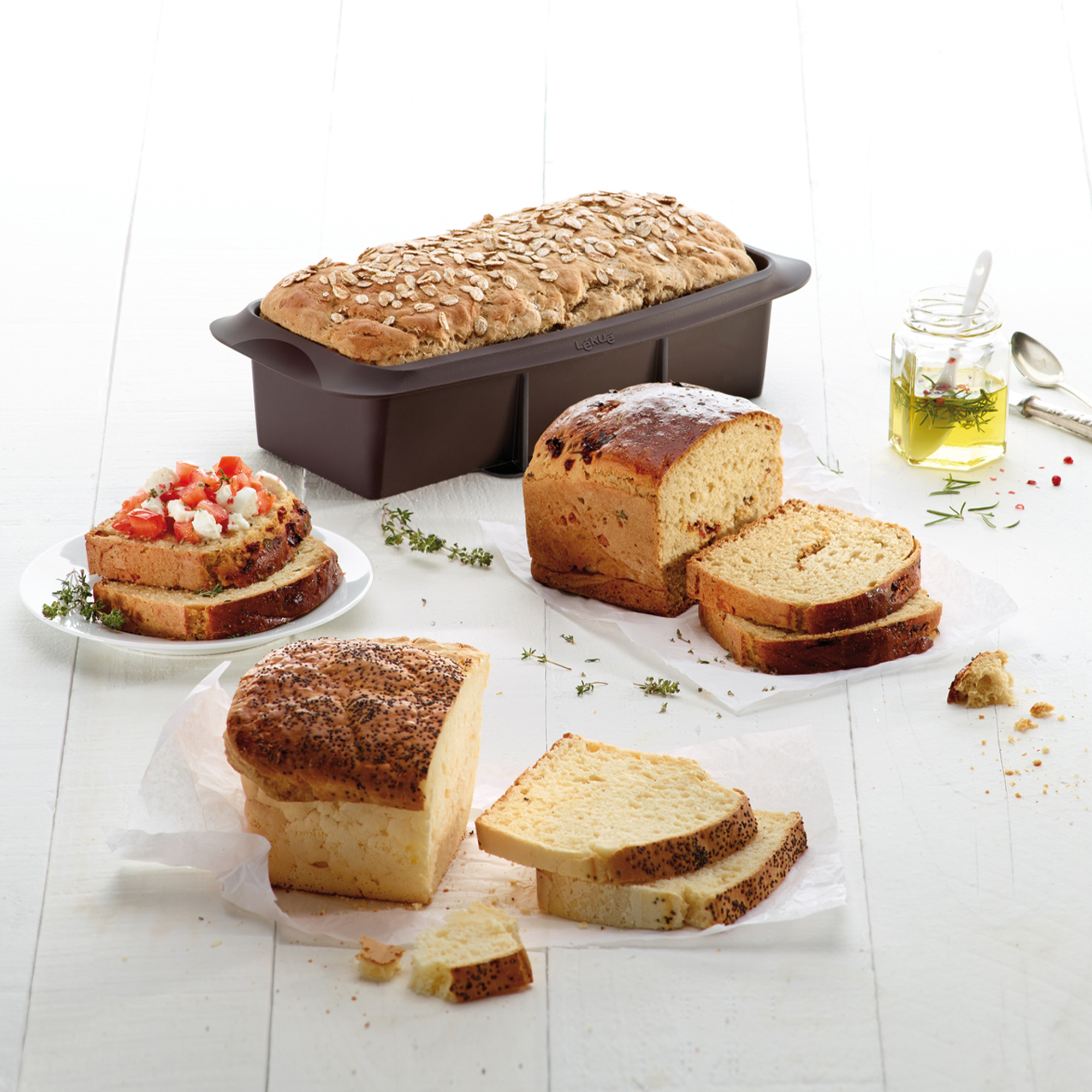 Several breads in and beside a silicone loaf tin