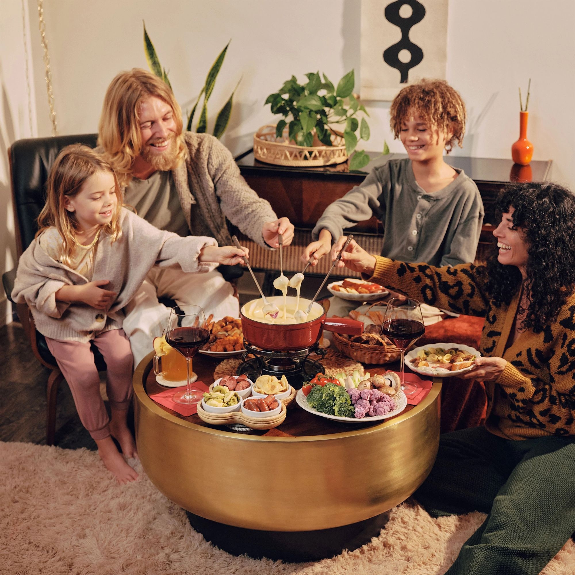 Smiling family enjoying cheese fondue together