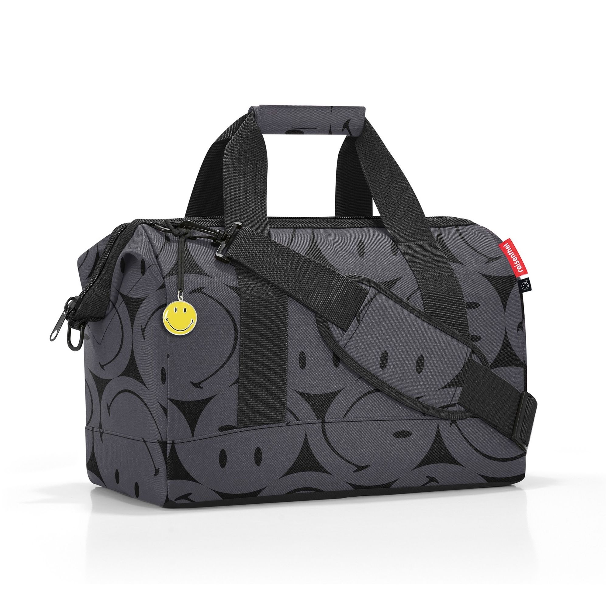 Grey travel bag with black smileys and shoulder strap