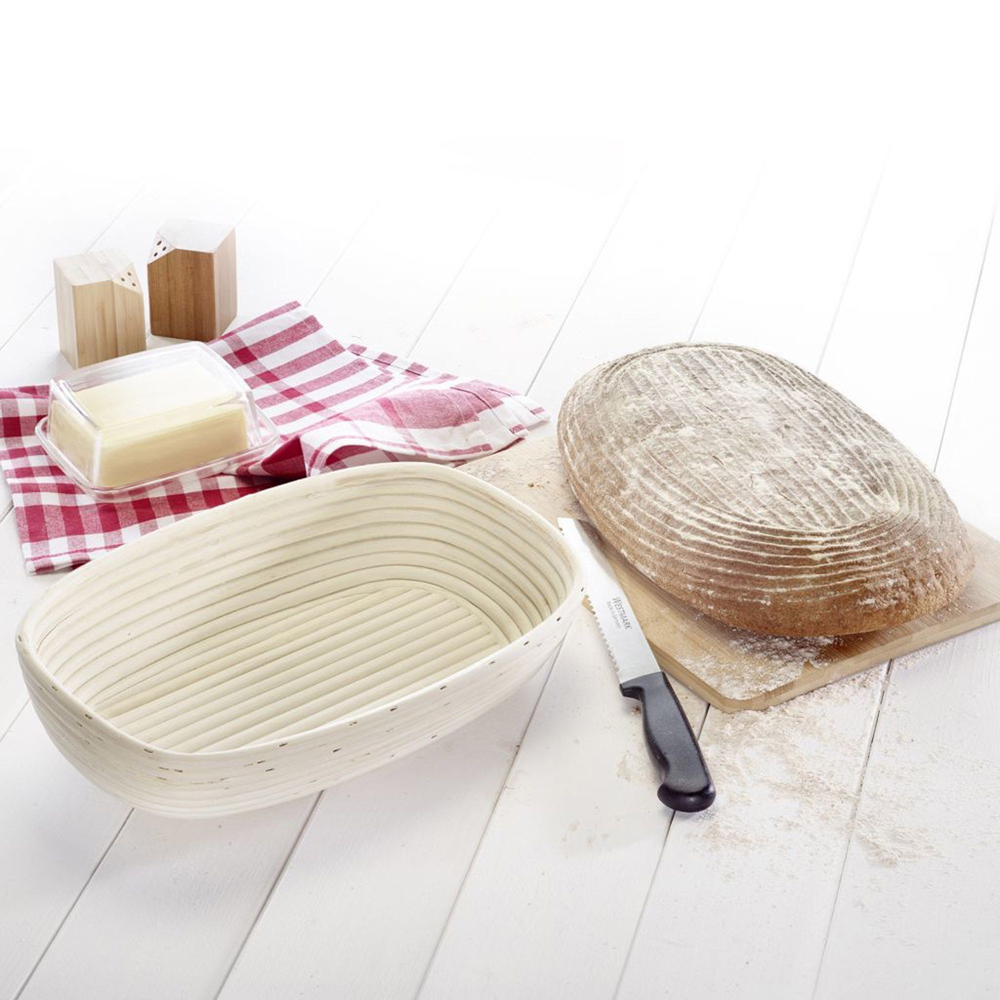 Oval rattan proving basket with loaf of bread
