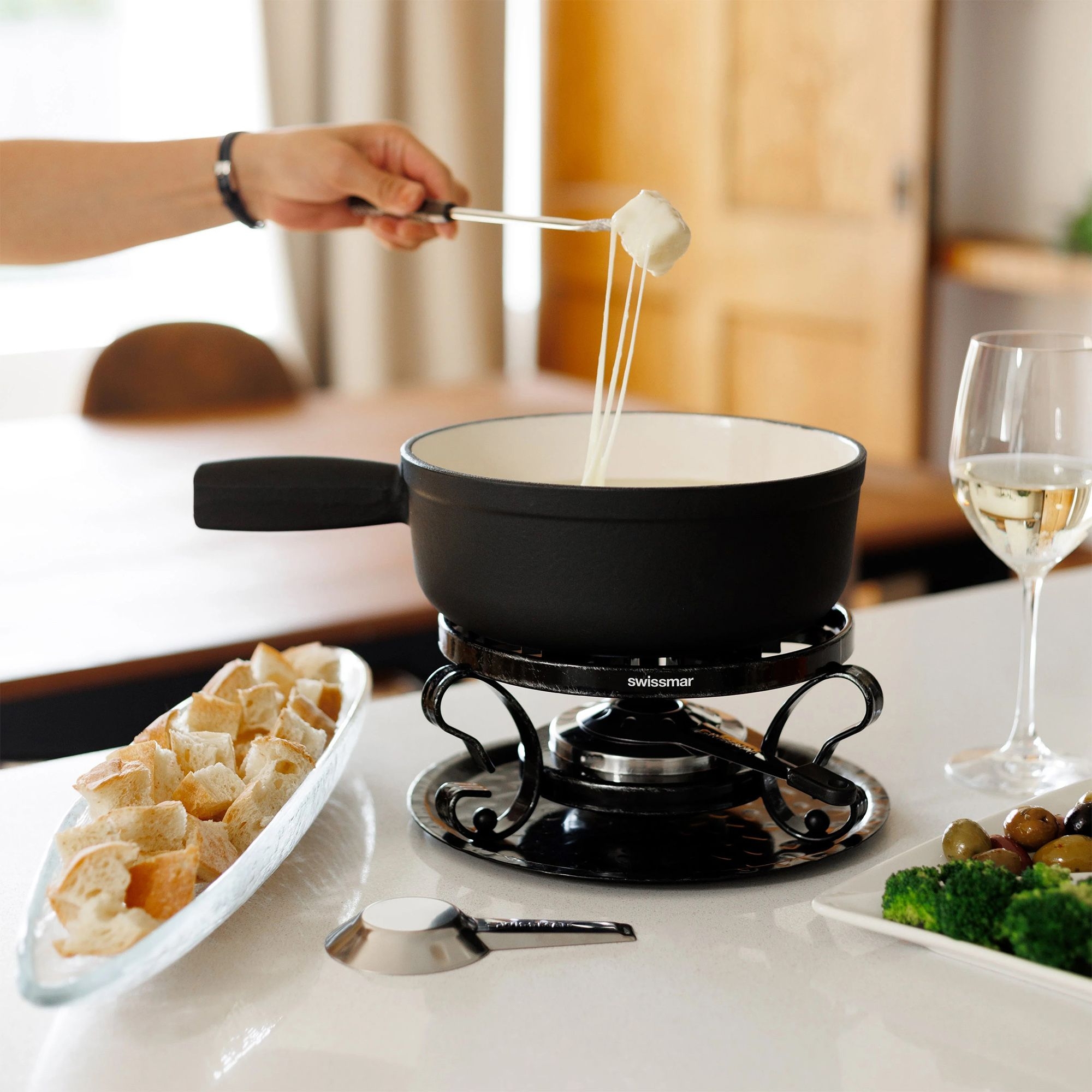Black cheese fondue set with bread and wine