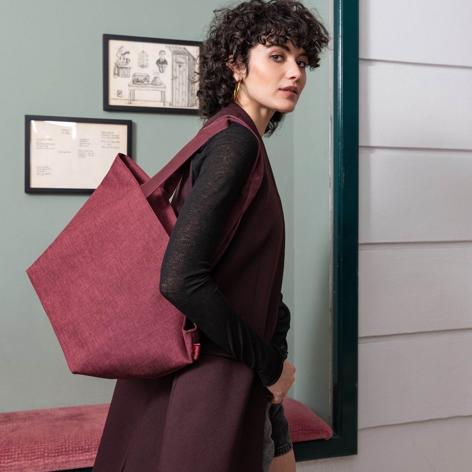 Woman with burgundy fabric tote bag over shoulder