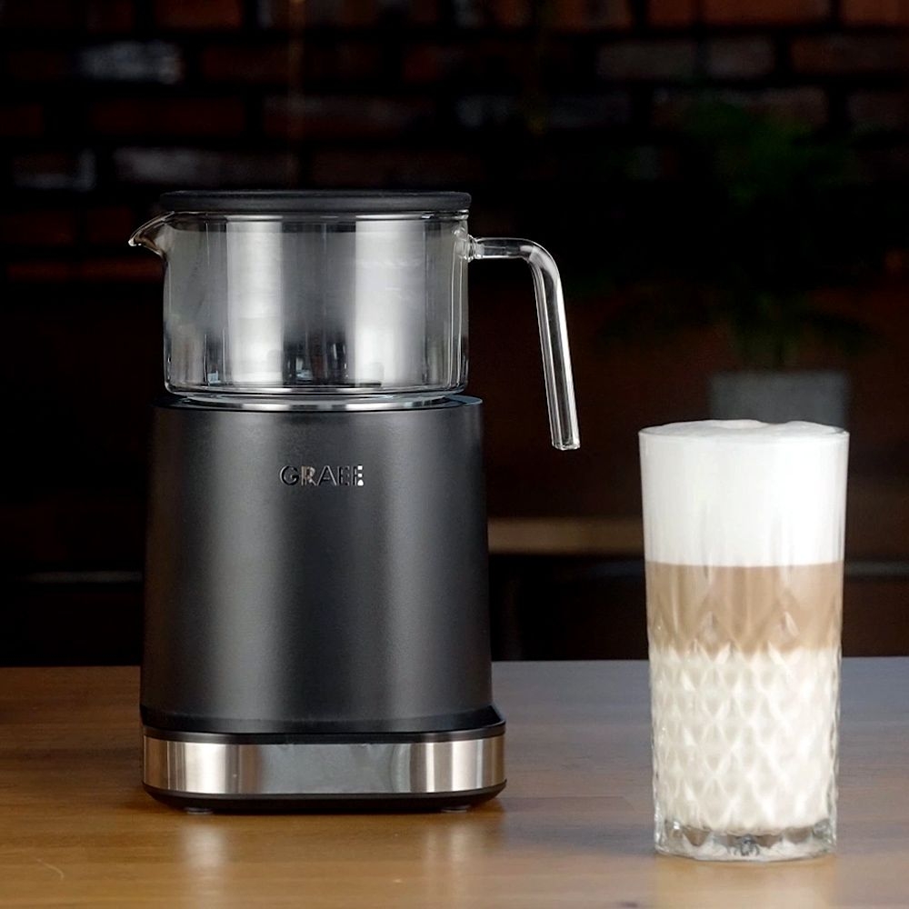 Black electric milk frother with latte macchiato glass