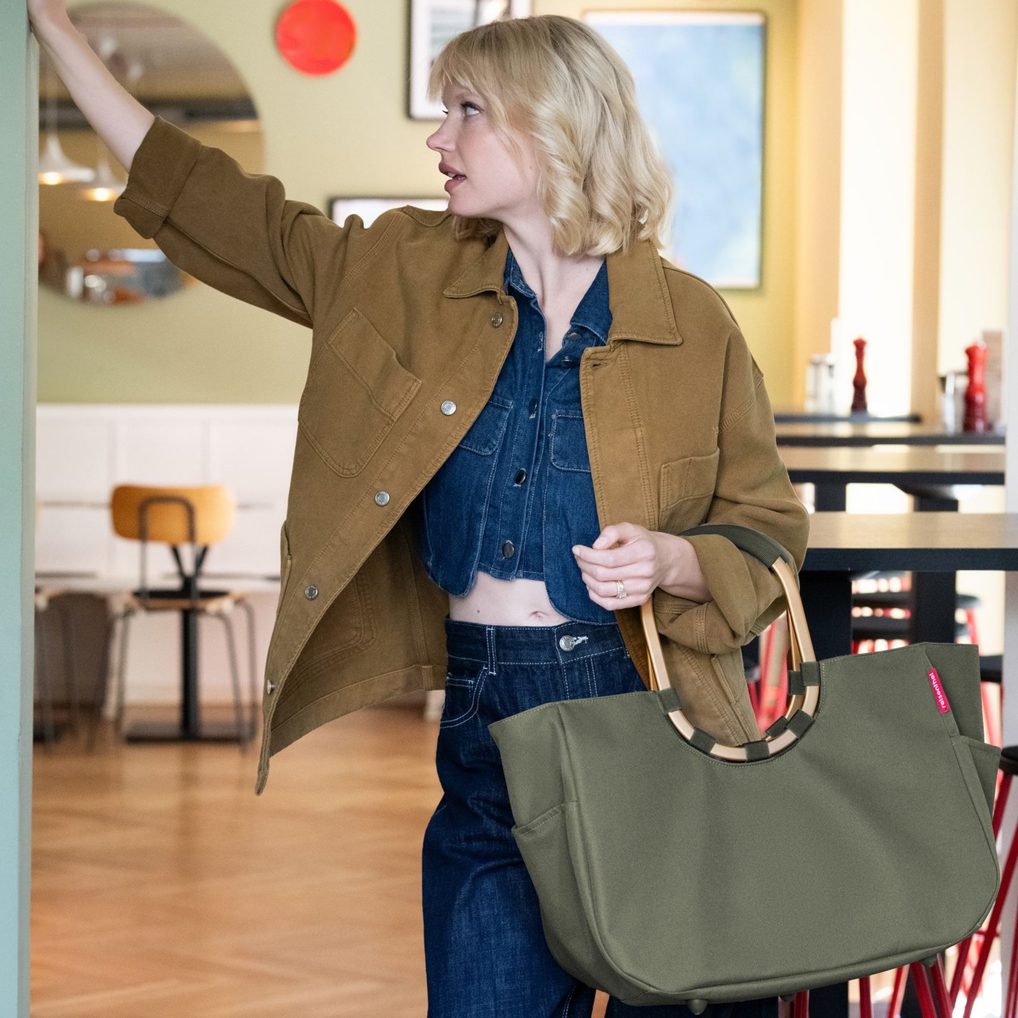 Woman with large olive green shopper bag