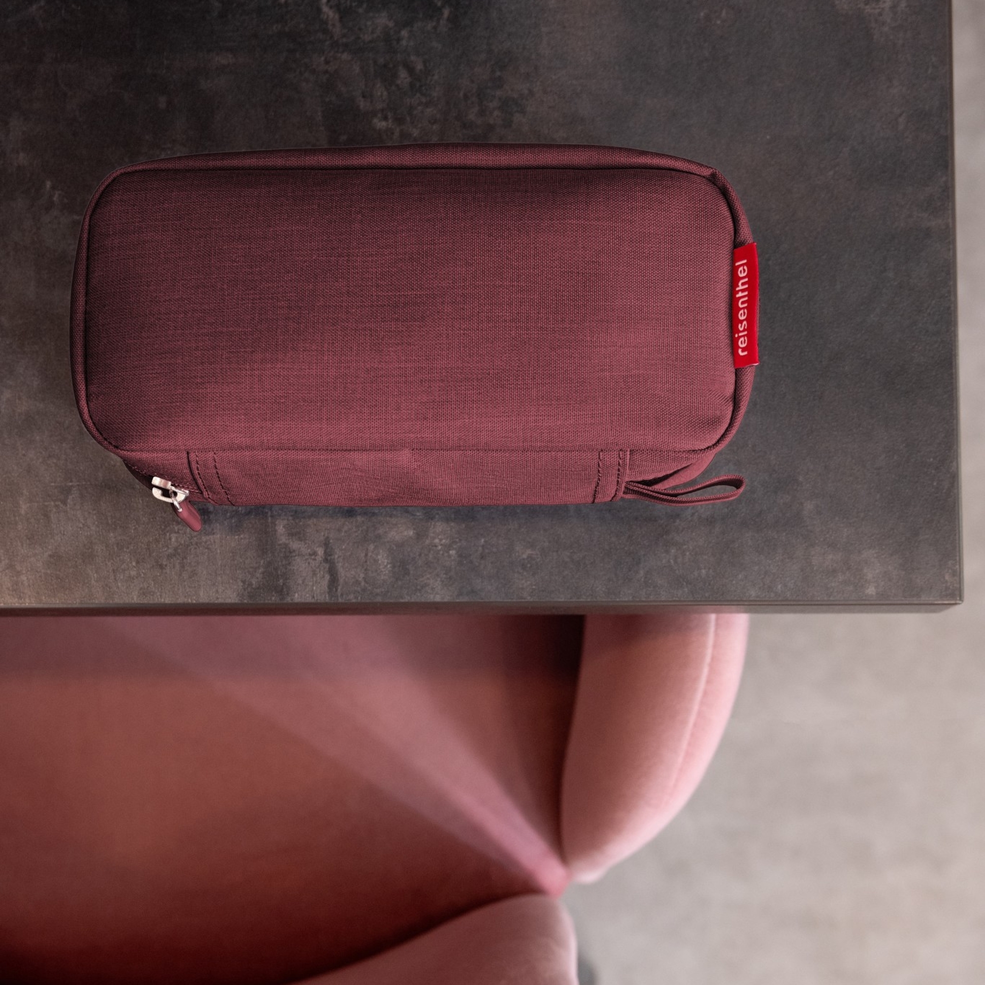 Bordeaux Reisenthel travel case on table