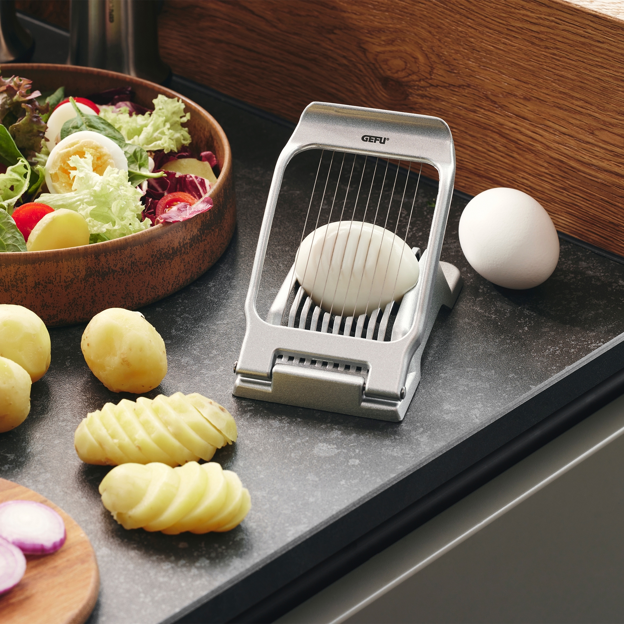 Metal egg slicer by GEFU with egg and salad