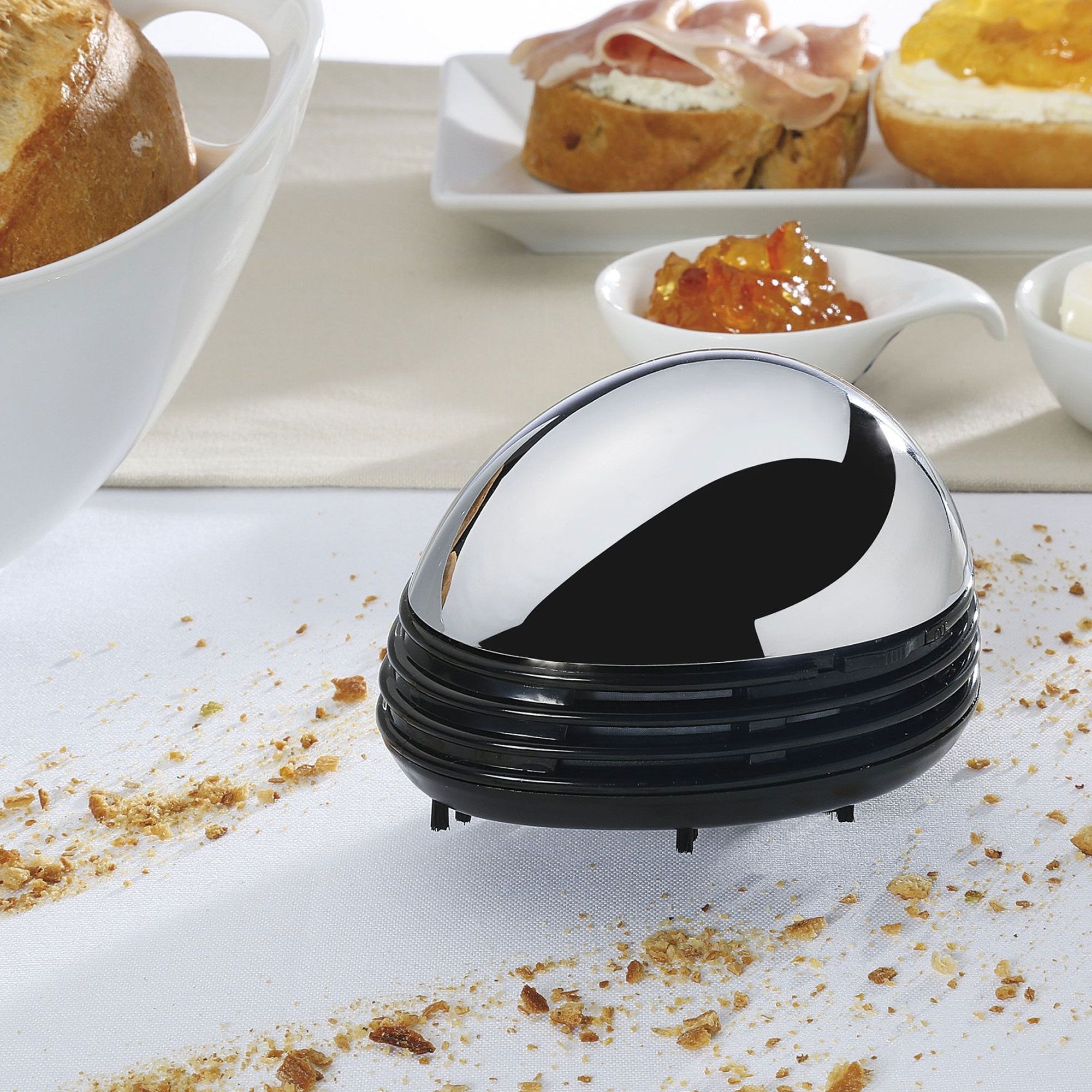 Small table crumb vacuum on white tablecloth