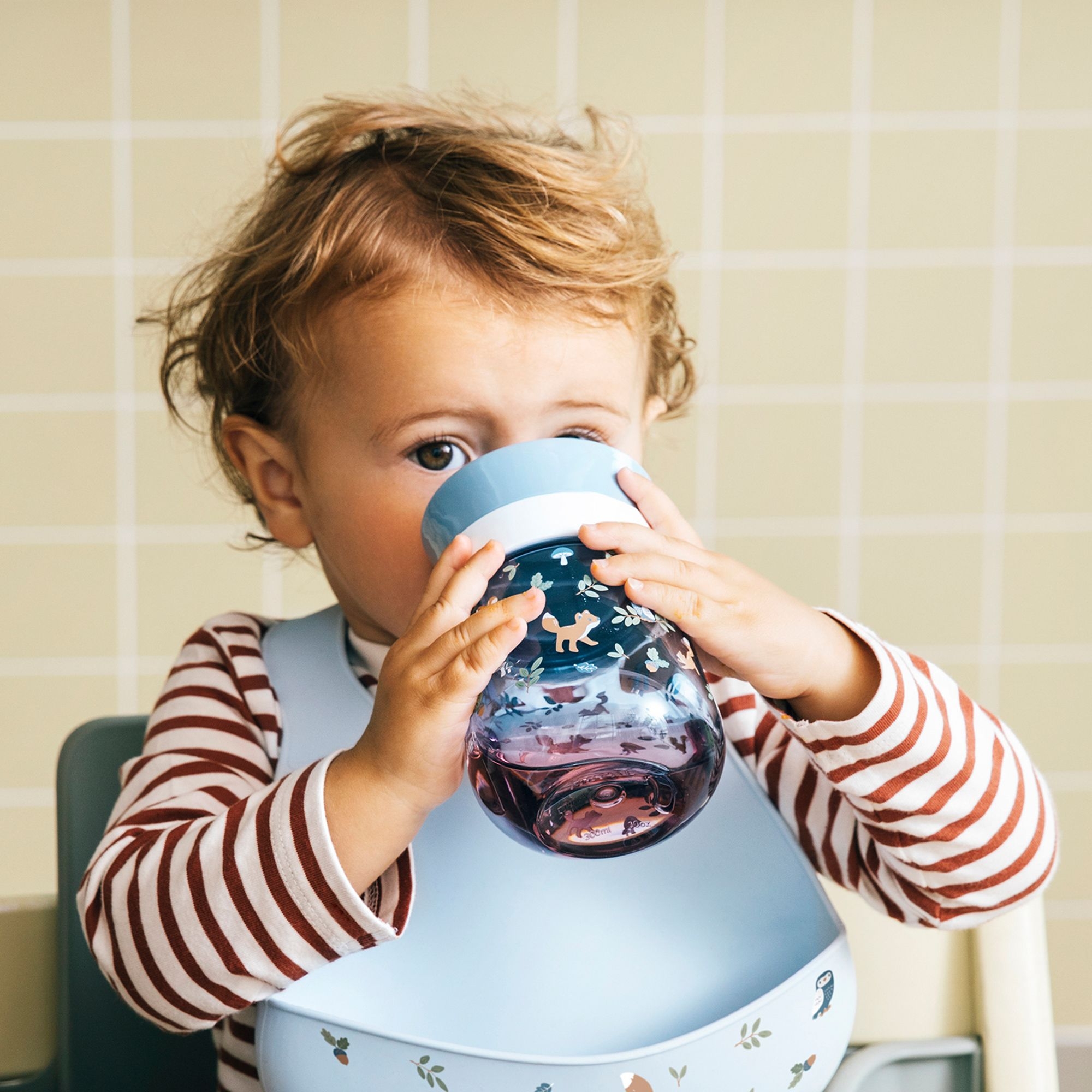 Toddler drinking from Mepal Mio 360° cup forest friends