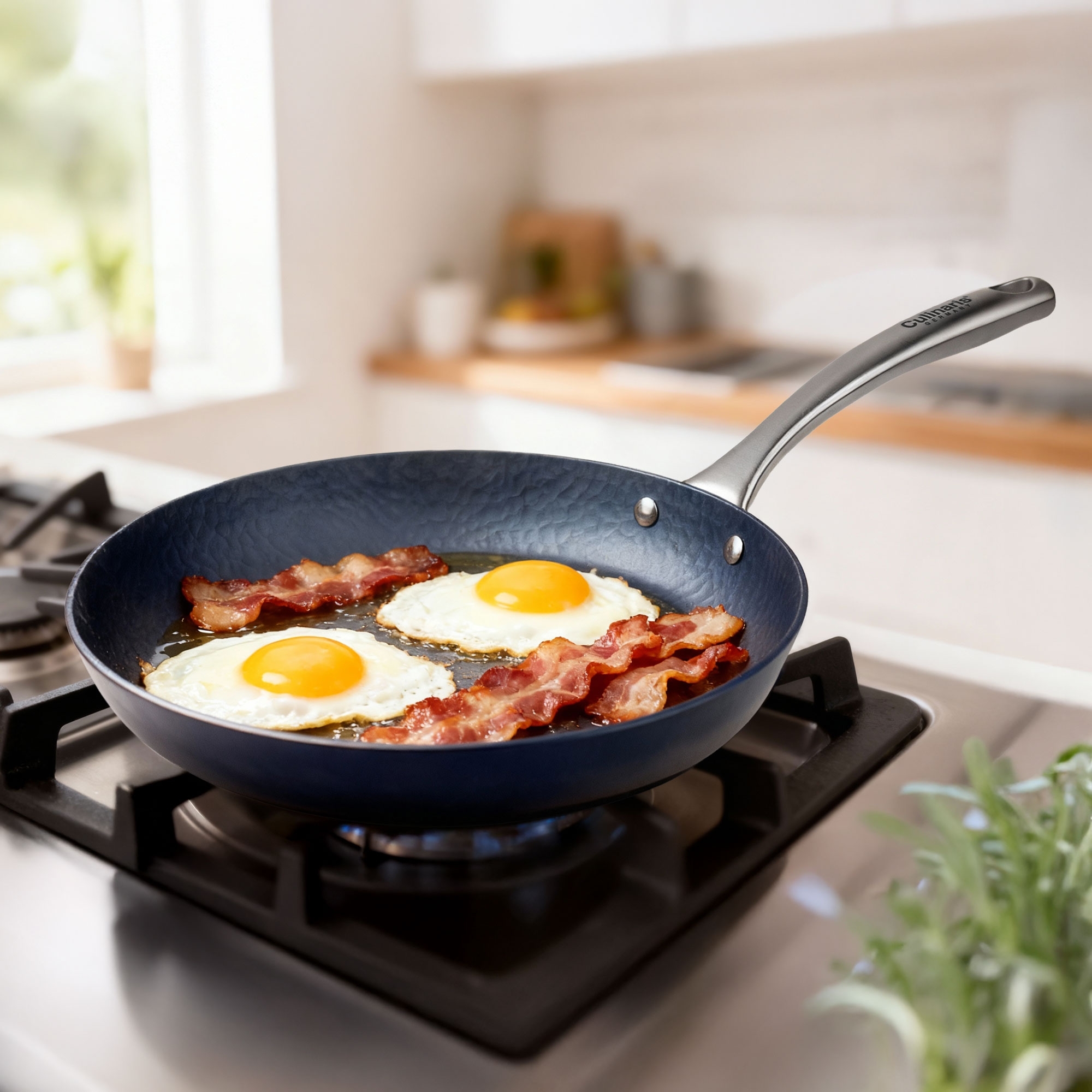 Frying pan with fried eggs and bacon on stove