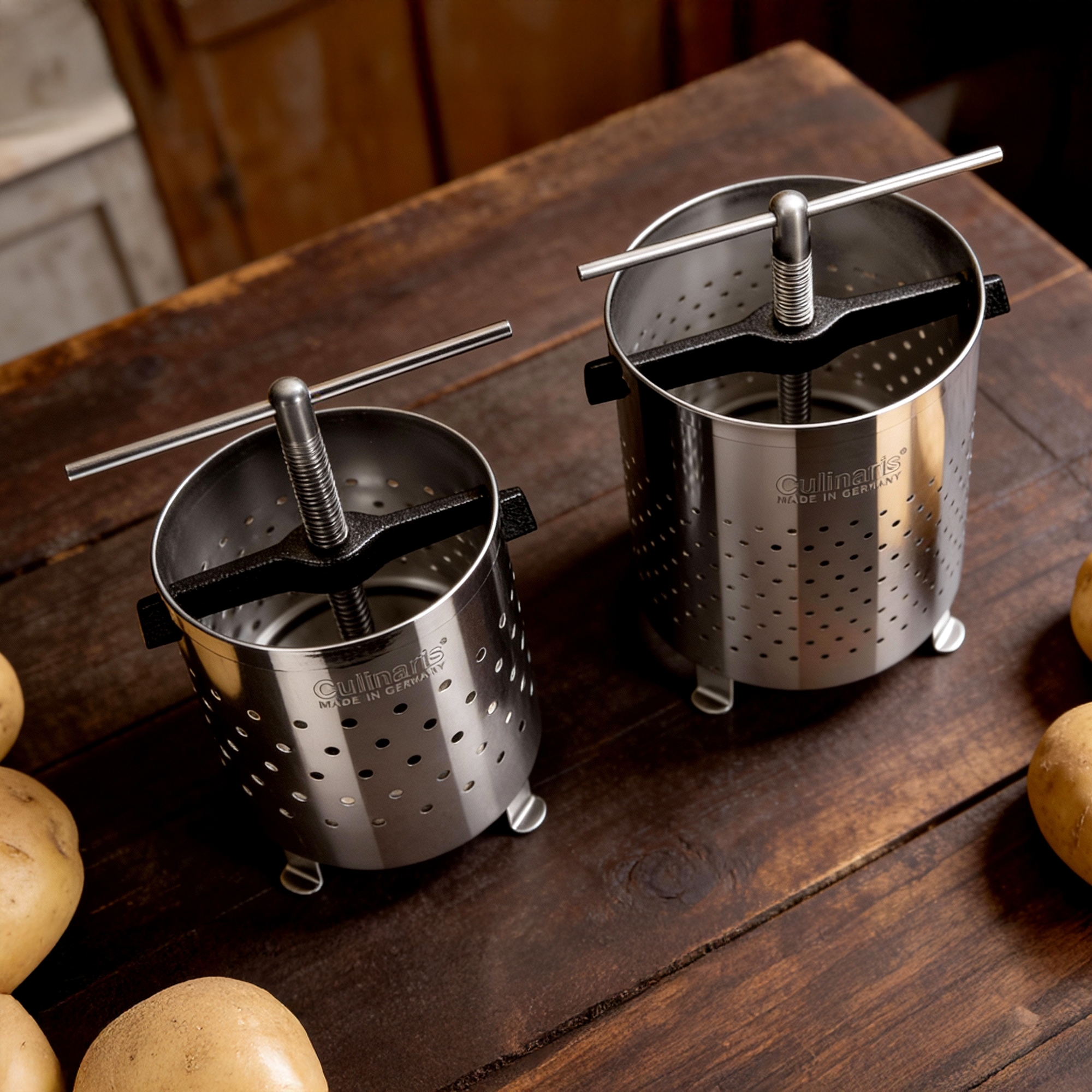 Two Culinartis stainless steel potato presses on table
