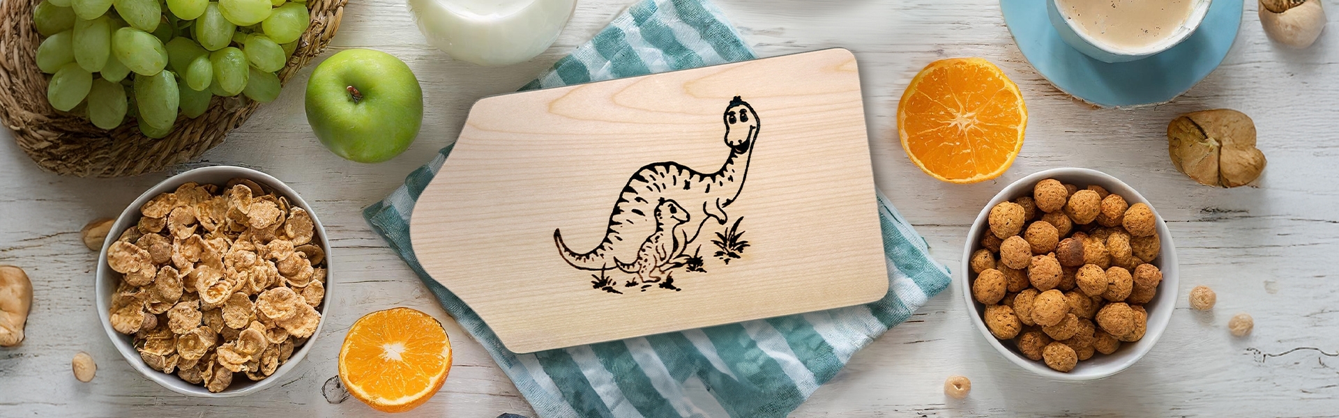Wooden board with dino engraving on breakfast table