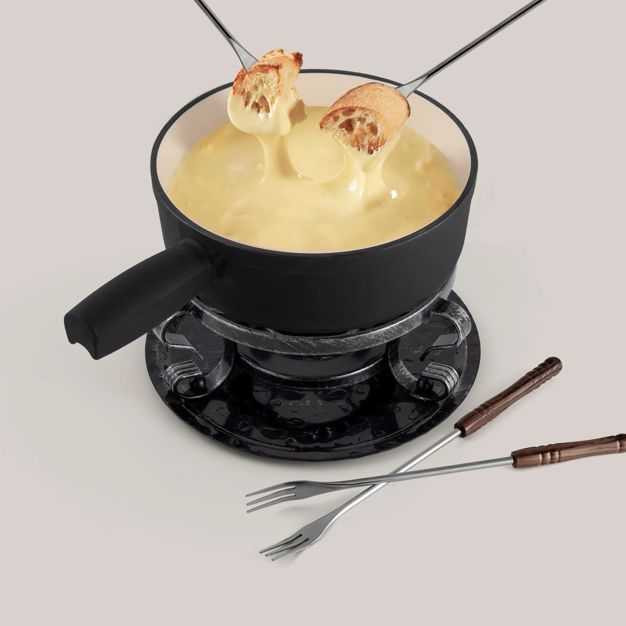 Black cheese fondue set with bread and forks