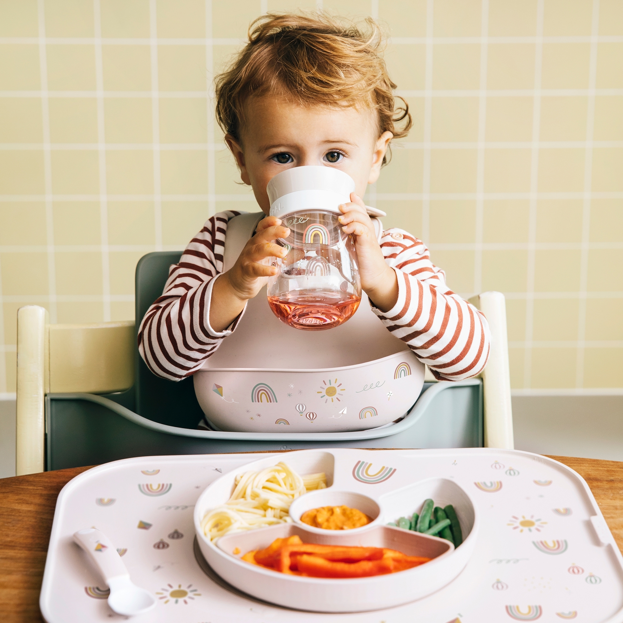 Toddler drinking from Mepal Mio 360° cup sunshine & rainbow