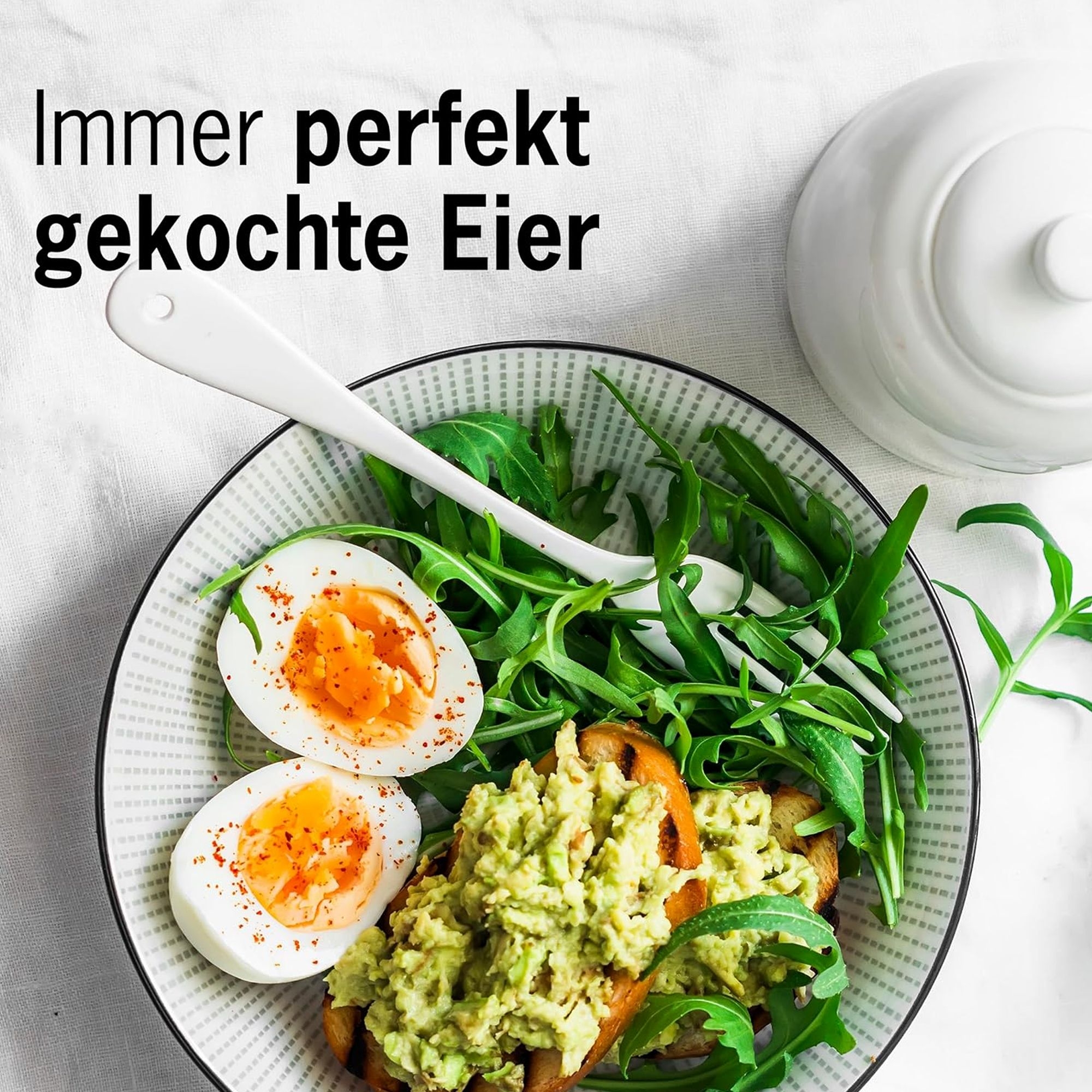 Plate with perfectly boiled eggs, avocado and rocket