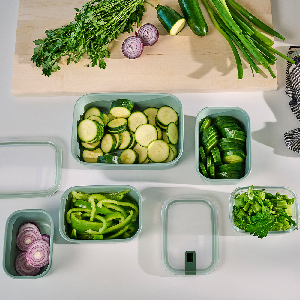 Filled food storage containers with fresh sliced vegetables