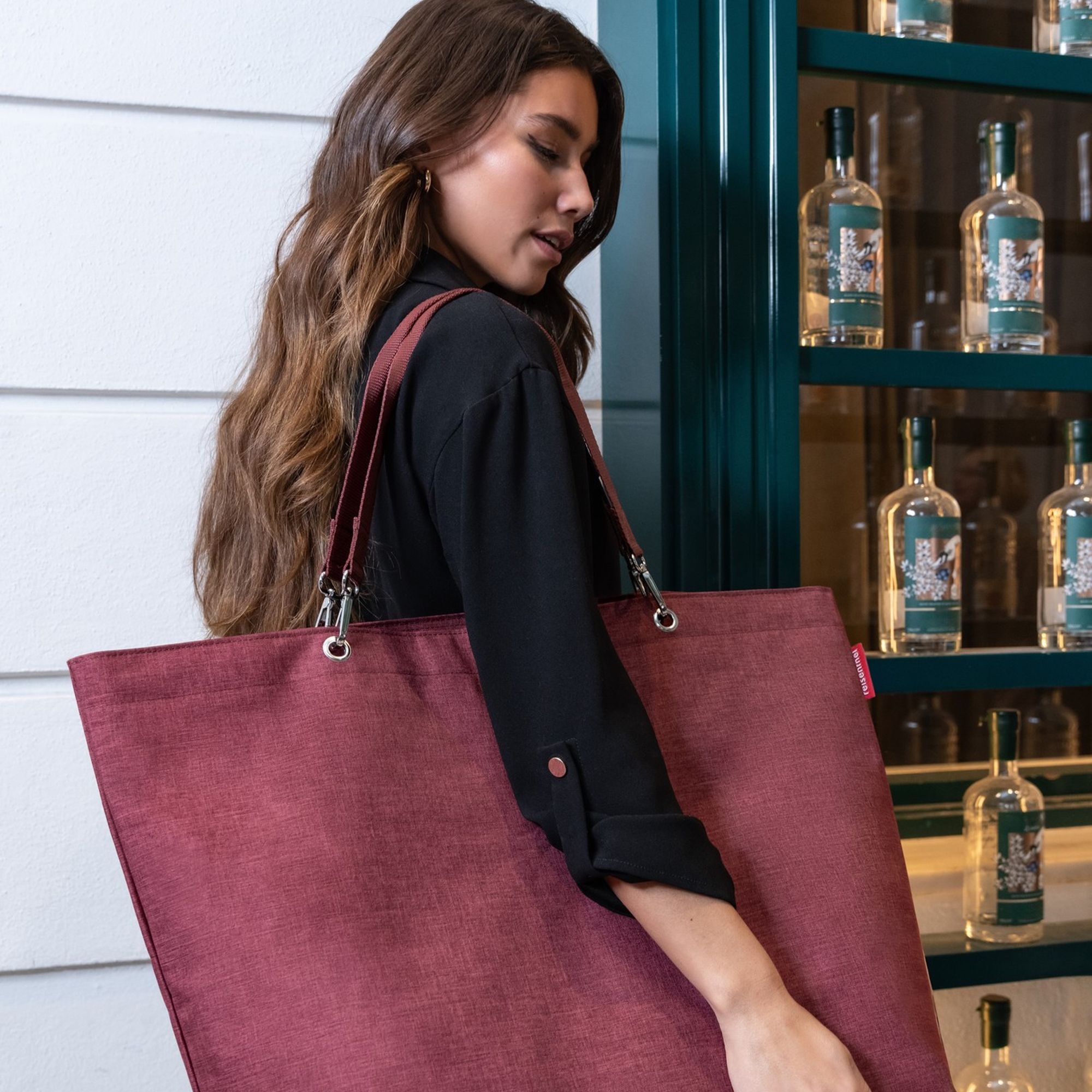 Woman with large dark red shopper bag