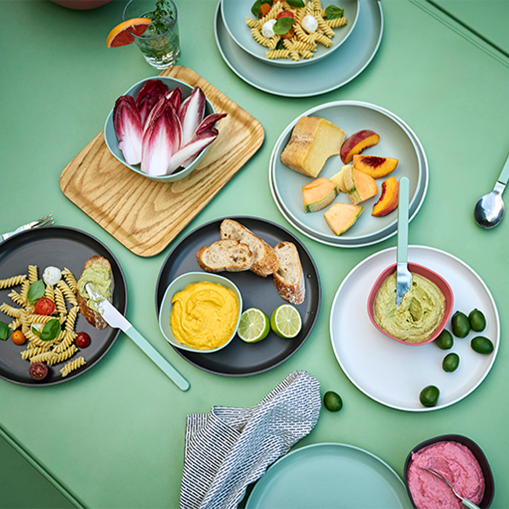 Colourful table with snacks on modern plates