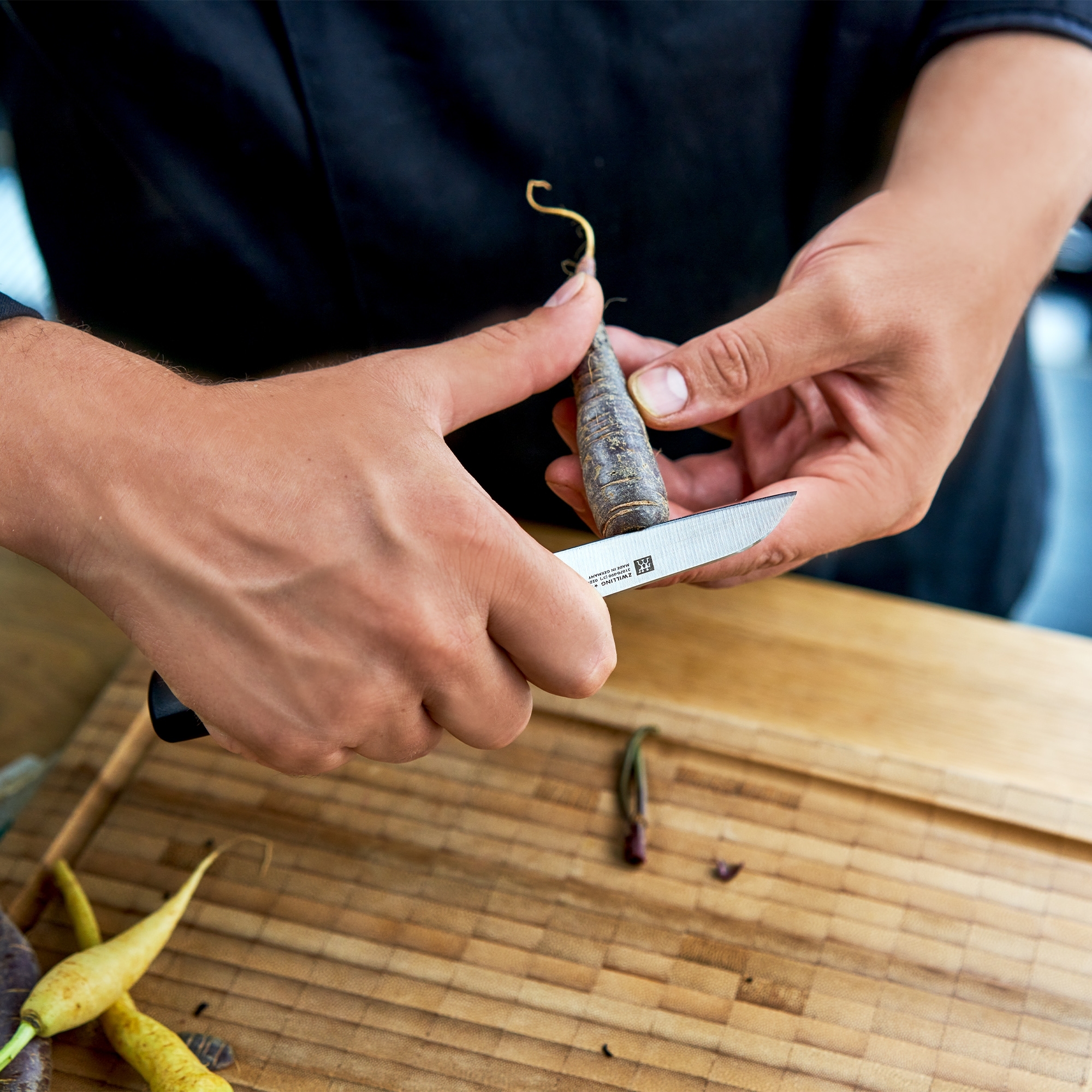 Hand peeling carrot with small paring knife