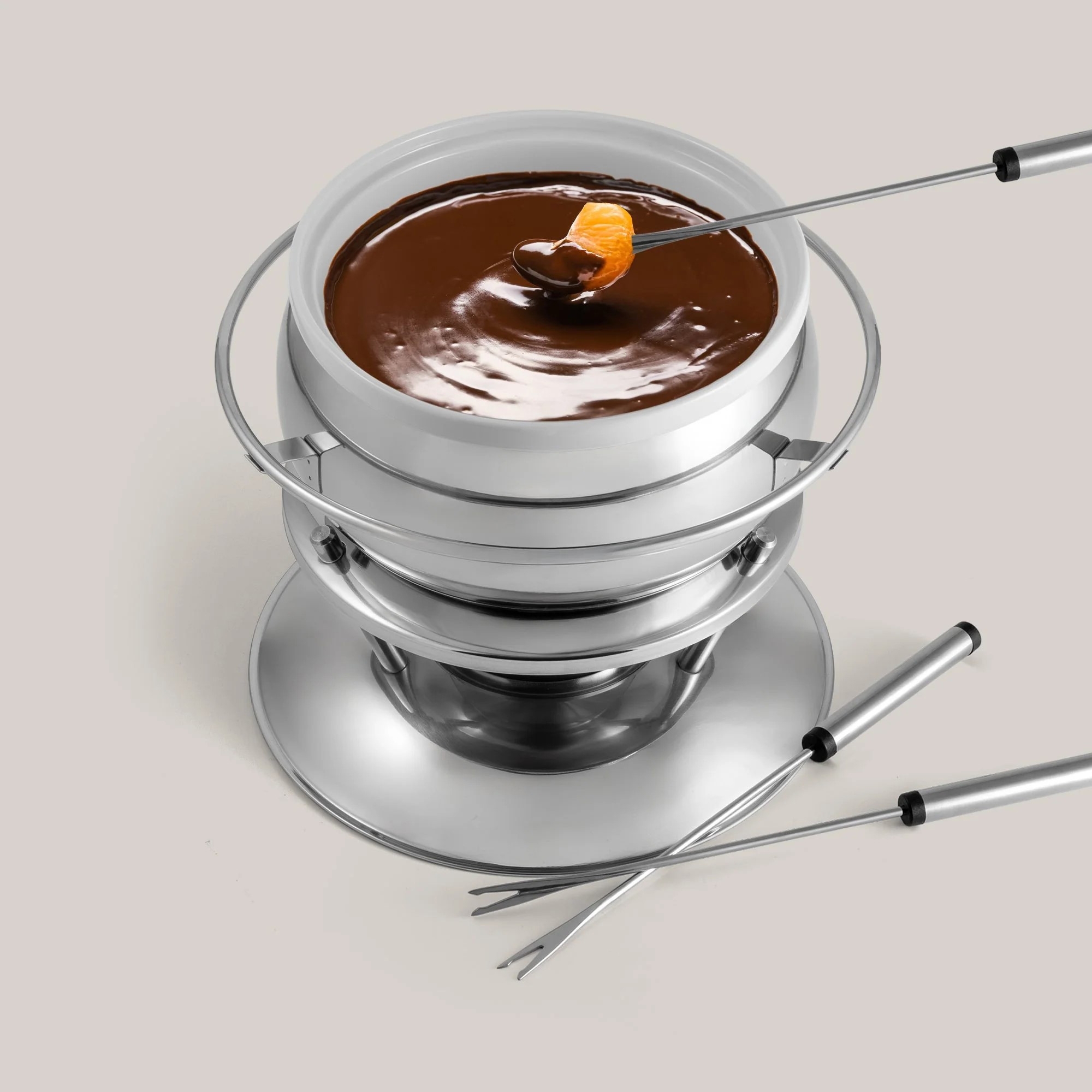 Round stainless steel fondue set with melted chocolate