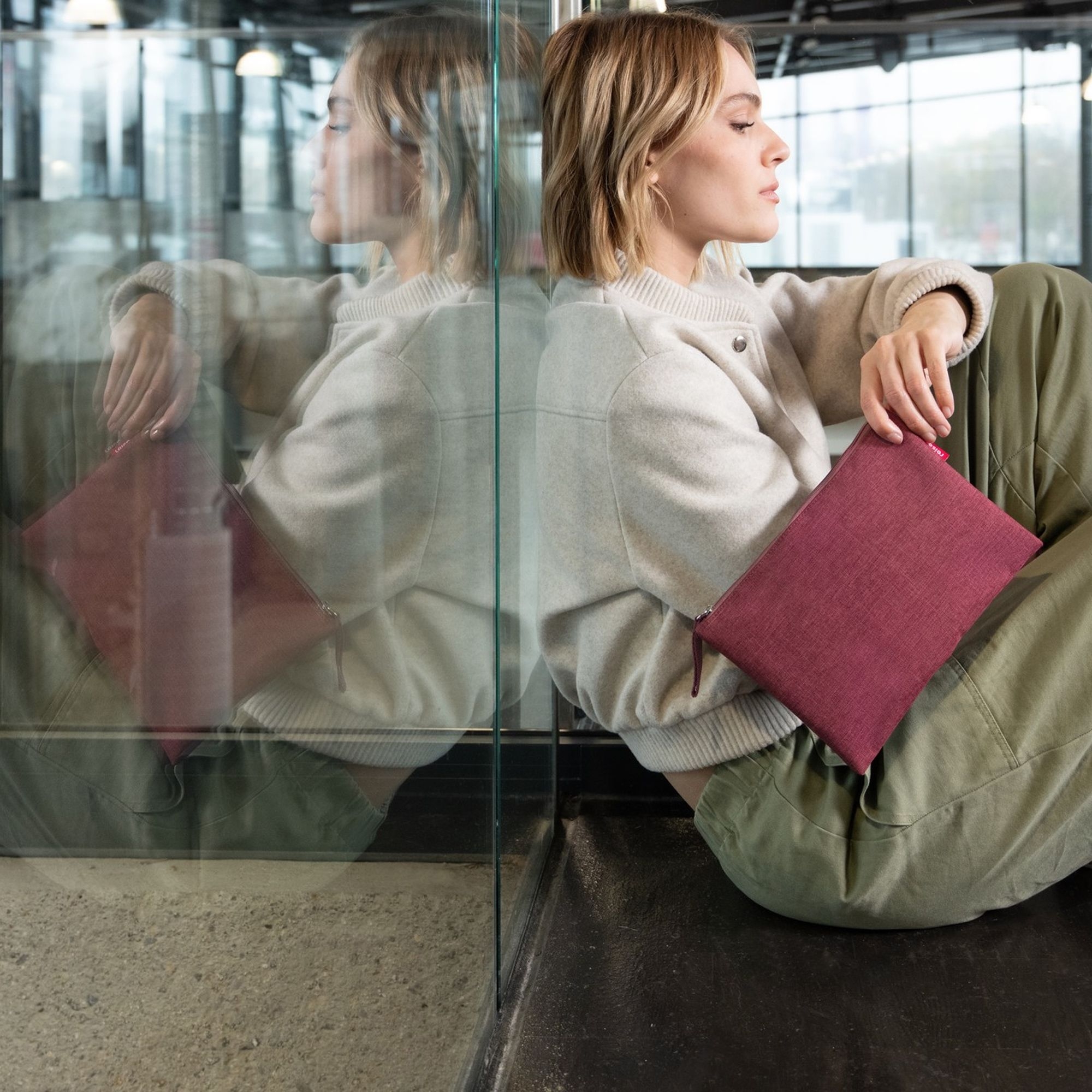 Woman with berry clutch in modern urban style