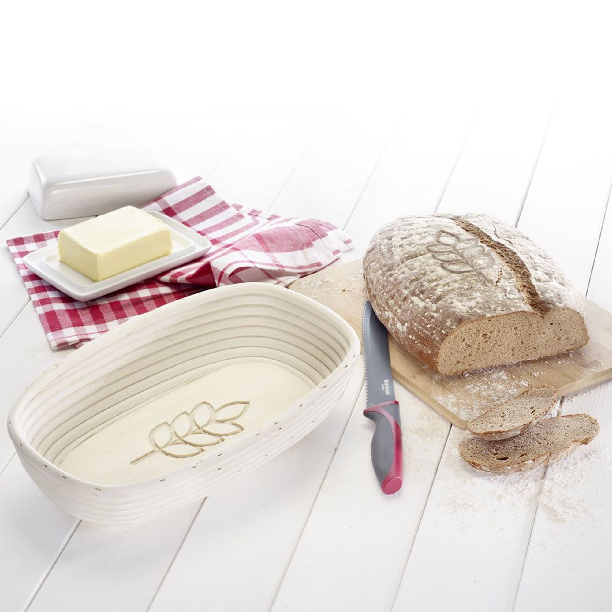 Oval proving basket with bread and bread knife