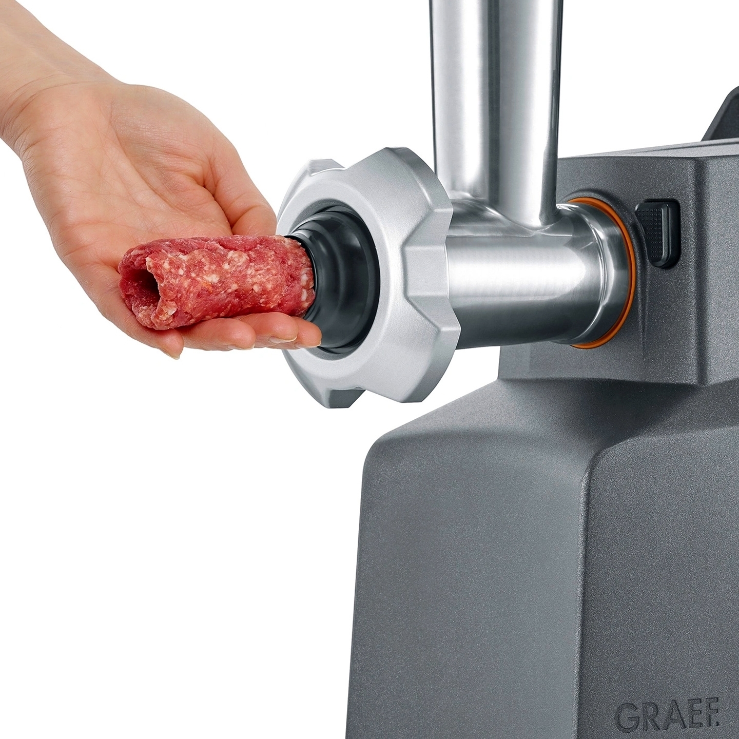 Hand inserting sausage meat into Graef mincer