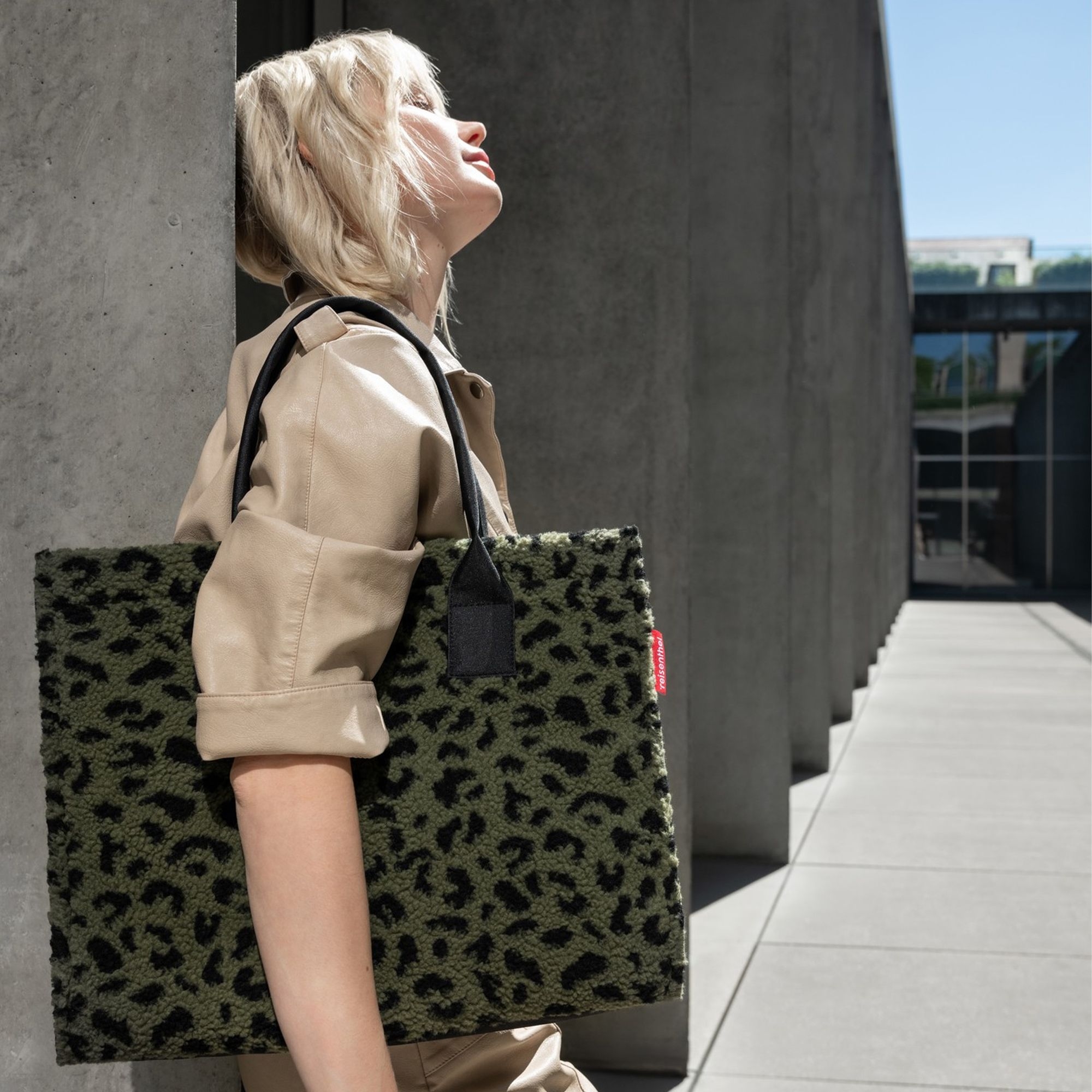 Woman carrying green leopard print plush bag