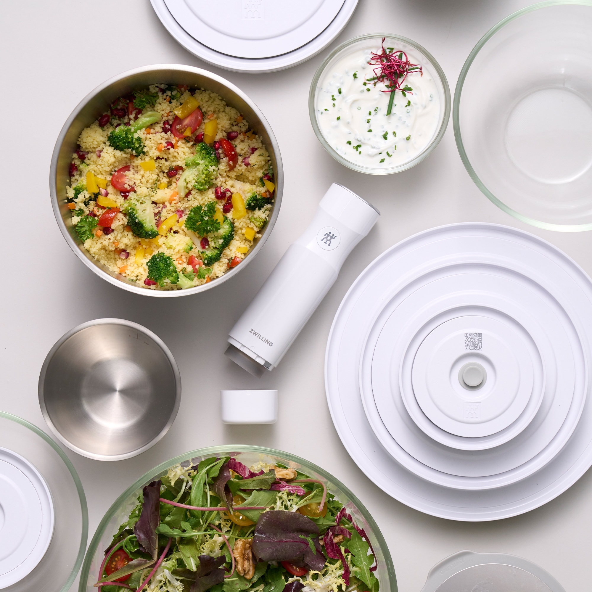 Salad ingredients and Zwilling spice shaker on white backgro