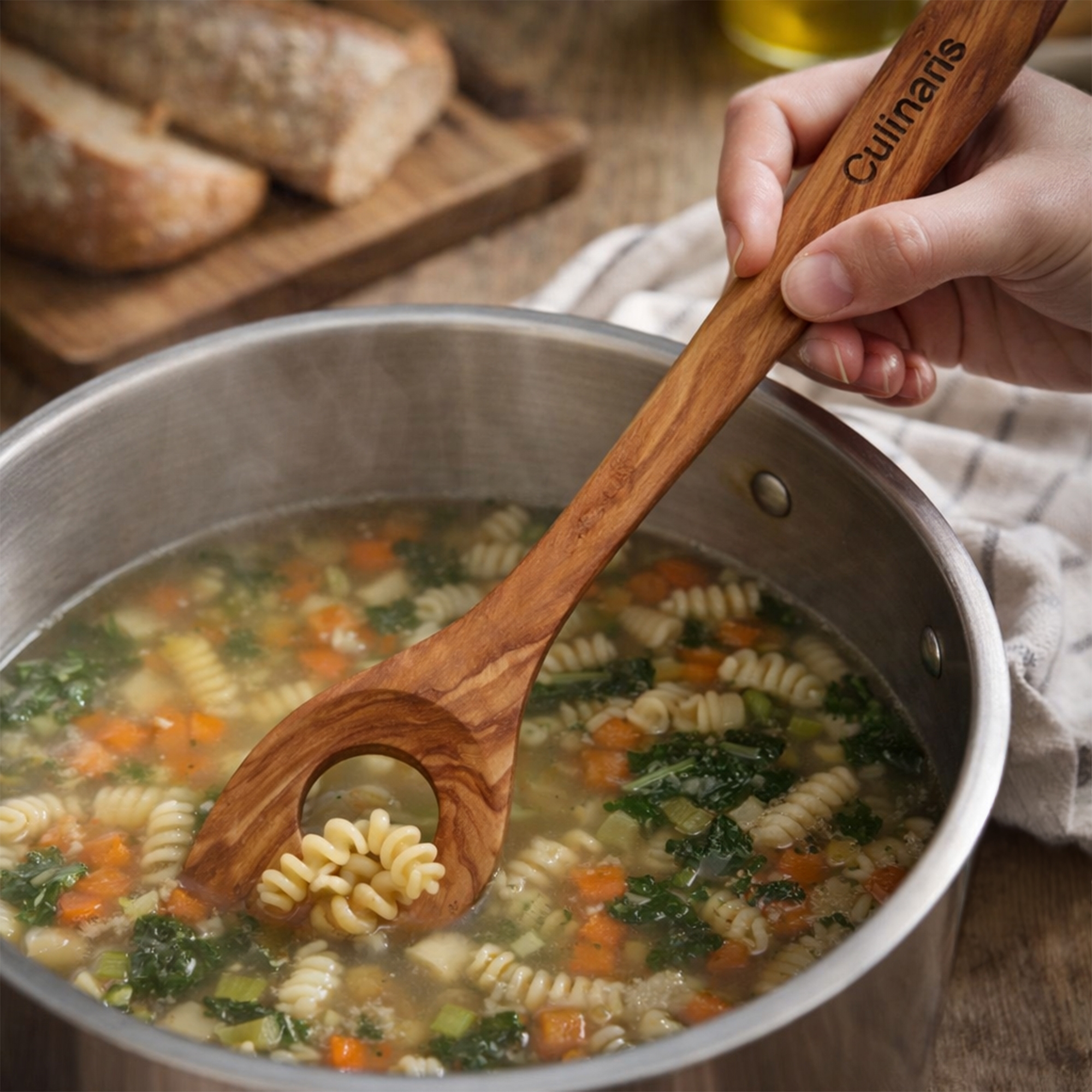30 cm olive wood slotted spoon by Culinaris in use