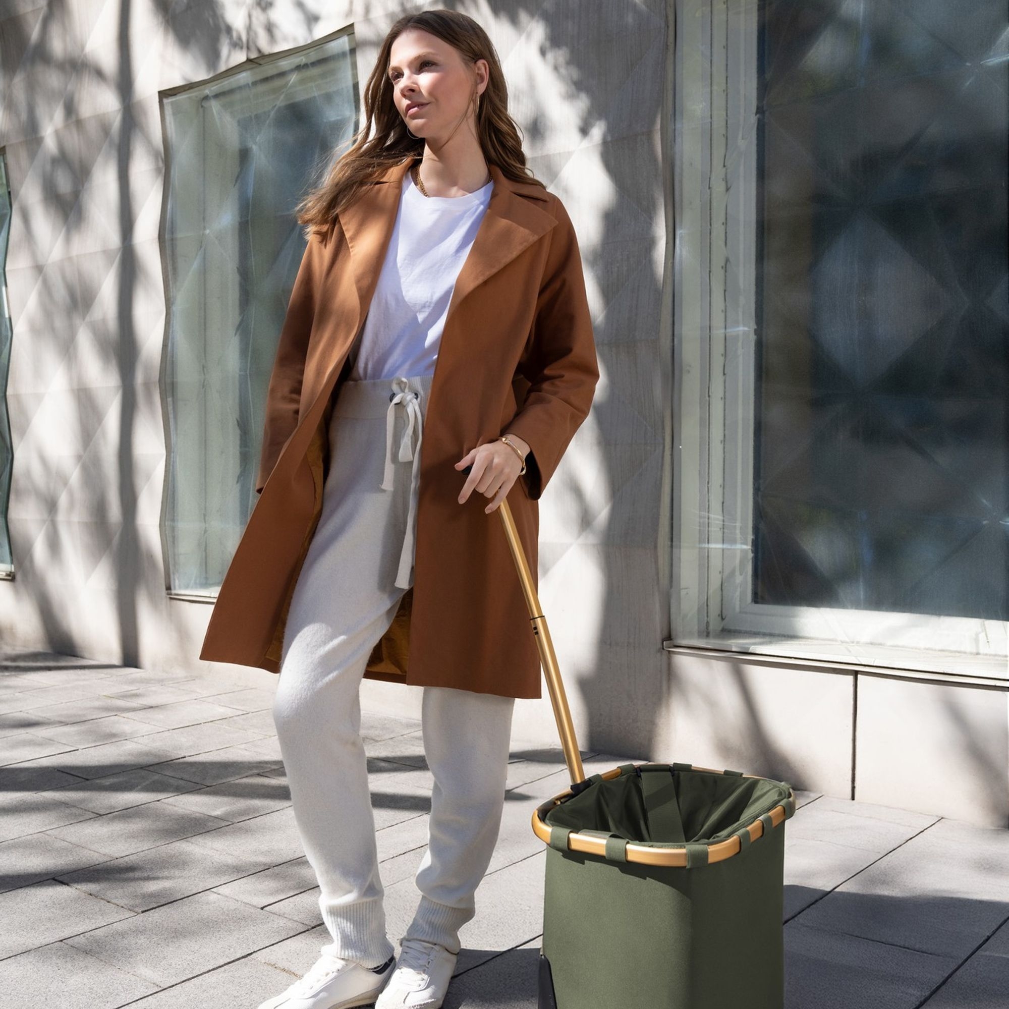 Woman in cognac coat with joggers