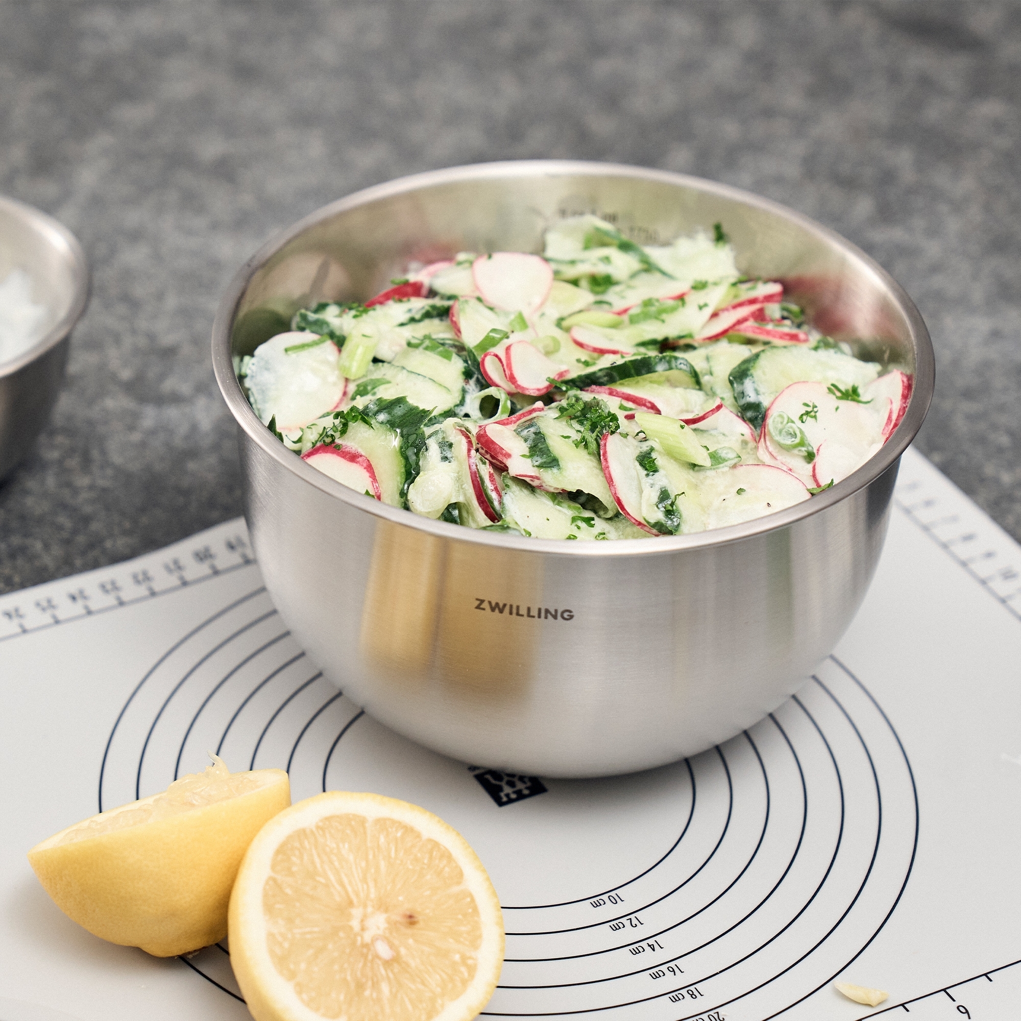 Fresh cucumber radish salad in stainless steel bowl