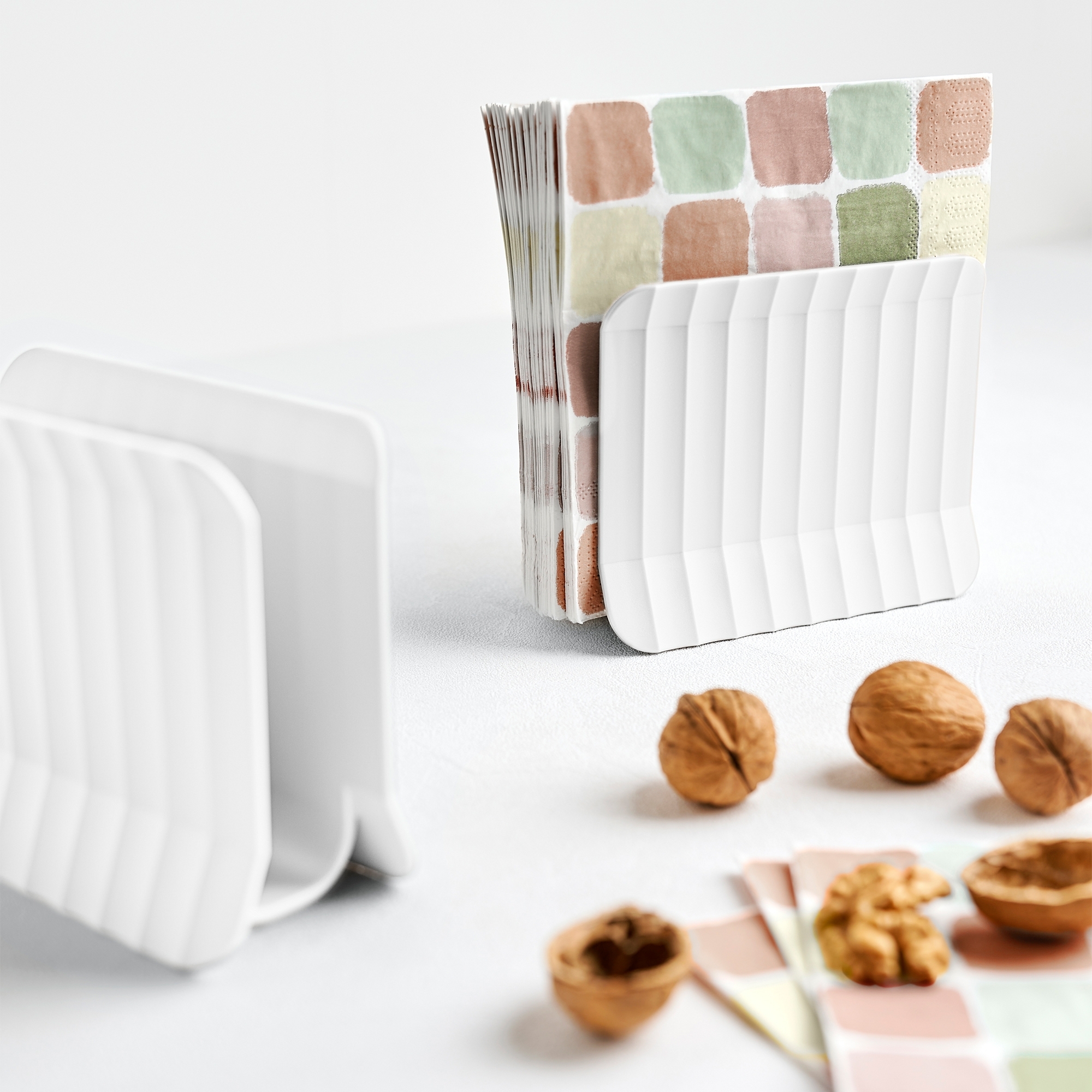 White napkin holder with colourful paper napkins