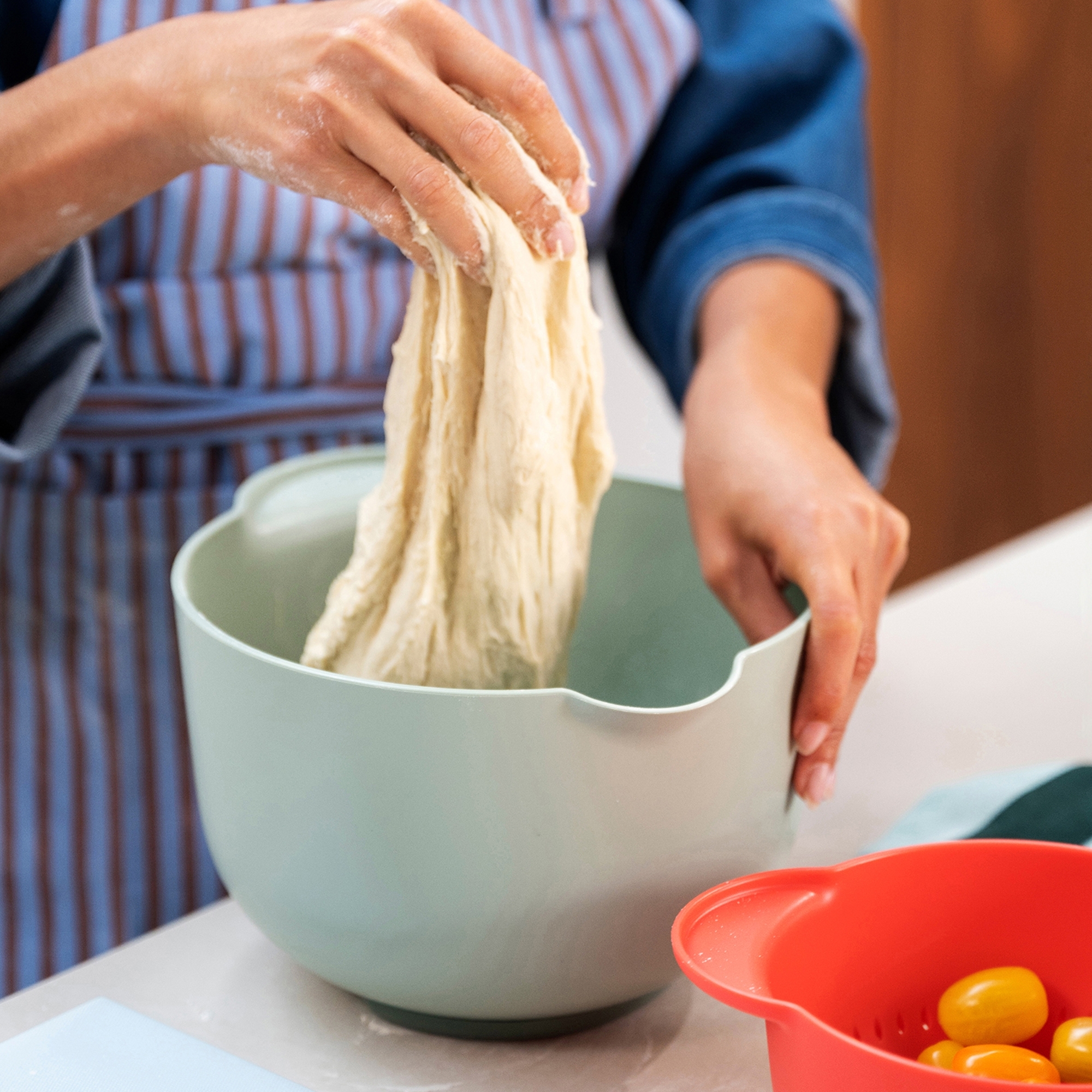 Person kneading dough in Mepal Chef It mixing bowl