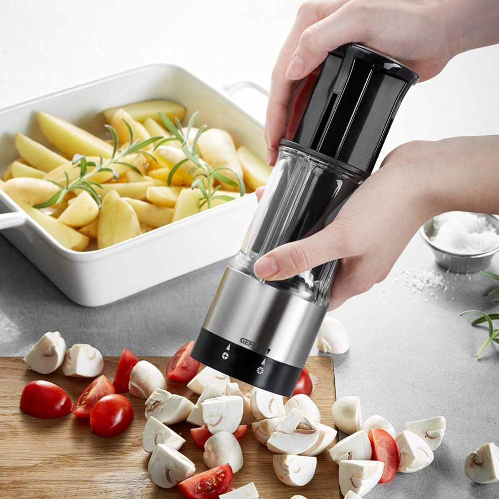 Electric mini chopper cutting vegetables on board