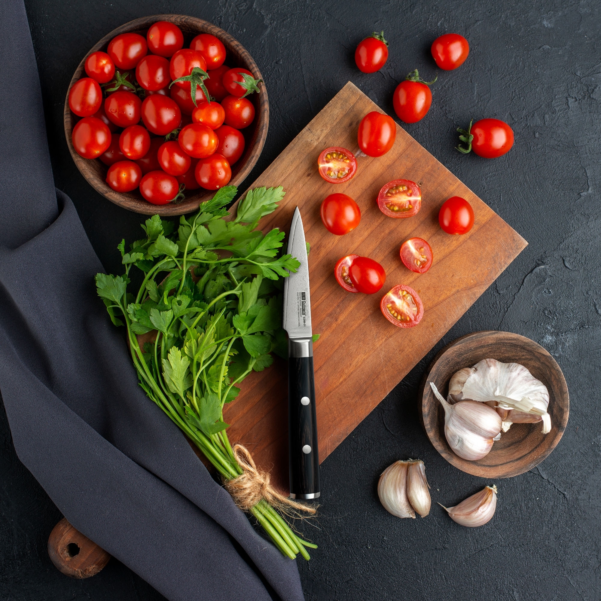 Fresh cherry tomatoes, parsley and garlic on cutting board w